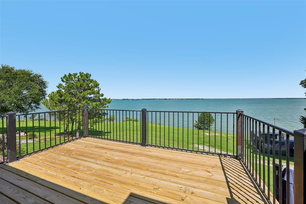 Vacation every day in this beautifully updated waterfront retreat on the shores of Lake Ray Hubbard! Wake up to breathtaking sunrises and unwind with spectacular sunsets from two levels of private decks, creating the perfect peaceful setting. This move-in-ready home offers a unique floor plan with each bedroom on its own level, providing privacy and flexibility. The upstairs bedrooms feature en-suite baths, making it ideal for guests, family, or multi-generational living. Recent updates and improvements include granite countertops in the kitchen and both bathrooms, new bathroom vanities, updated hardware, light fixtures, tile flooring in the dining room and bathrooms, new carpet, fresh interior paint, and new satin nickel doorknobs throughout. Energy efficiency and comfort are enhanced with new energy-efficient windows, LED recessed lighting throughout, ceiling fans in the bedrooms and living room, a new hot water heater, and kitchen appliances installed in 2023. Additional upgrades include a new balcony, new gutter installed in 2026, extra storage created under the stairs, and attic decking for additional storage space.
Located in a sought-after gated community, residents enjoy resort-style amenities including a community pool, tennis courts, and a 9-hole golf course. Whether you're looking for a primary residence, weekend getaway, or lock-and-leave lifestyle, this lakefront gem delivers incredible views, extensive updates, and a true waterfront lifestyle. Come experience lake living at its finest on Lake Ray Hubbard!