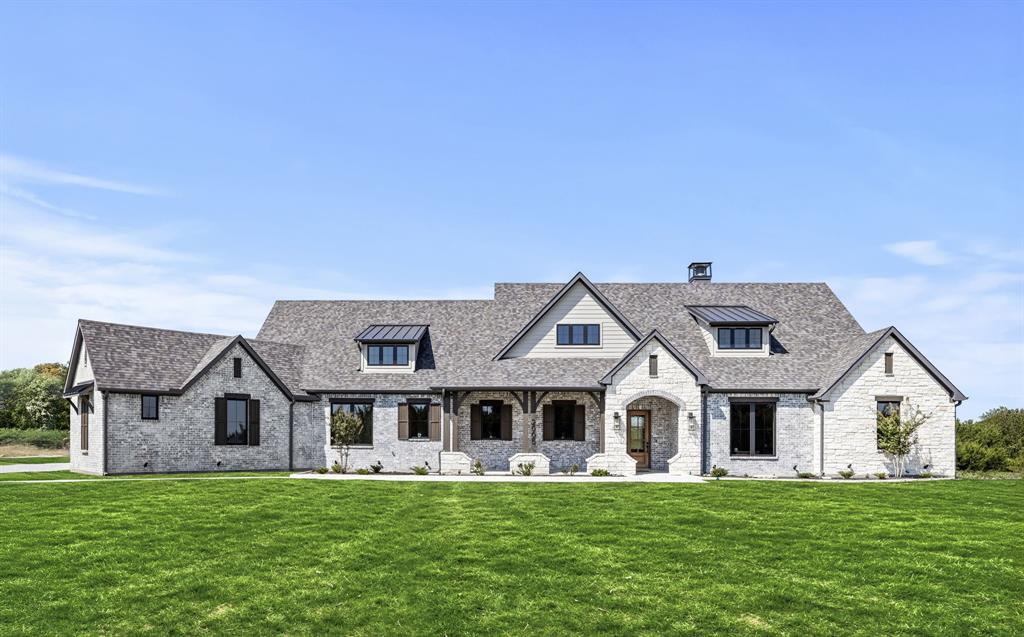 Built by Fourlight Custom Homes, this 4-bed, 4.5-bath residence blends artistry and comfort in every detail. From the moment you arrive, upgraded brick and stone, Hardie siding, and cedar porch ceilings set a welcoming, timeless tone. Inside, hand-scraped wood floors and soaring floor-to-ceiling Andersen windows pair with a high-efficiency Lennox system and spray-foam insulation to create a home that’s as energy-smart as it is beautiful. The grand living room, crowned with 12-foot ceilings and a wood-burning (gas-assist) fireplace, invites gatherings of every size. Sunlight pours through the windows and flows into the dining area and chef’s kitchen, where a Thermador built-in refrigerator and freezer, quartz countertops, soft-close cabinetry, and an expansive island inspire both quiet mornings and lively dinner parties. Behind it, a walk-in and butler’s pantry offer abundant countertop space and built-in cabinet storage galore, keeping everything organized and out of sight so the main kitchen stays pristine. A glass-walled study with custom built-ins provides a serene spot for work or reading, while a game room with dry bar and media space sets the stage for fun. Throughout the home, pre-wired sound and data drops mean you’re ready for today’s tech and tomorrow’s upgrades. The private primary suite is a true retreat, with spa-style bath featuring quartz counters, a steam shower with rain head and body sprays, a freestanding soaking tub, and a custom walk-in closet. Each secondary bedroom enjoys its own ensuite bath, ensuring comfort and privacy for family or guests. Step outside to a large covered patio with cedar ceilings, wood-burning (gas-assist) fireplace, and a built-in grill—perfect for year-round entertaining or quiet evenings under the stars. A water-softener system and three-car garage add everyday ease. Make this gem your new home today!