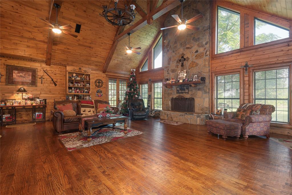 Listing Updated to 70 Acres w House and shop. Longhorn Hill Ranch offers A Real Log House 3800 sq ft w a Large Workshop plus a 4800 sq ft 2 bedroom, 1 bath and 2 half baths barndominium event center. This private Texas retreat offers the perfect blend of ranch living, recreation,and event potential. Located less than one hour from Downtown Dallas and DFW Airport, this unique 70+ acre property features, a 4 bedroom, 3 bath custom log home w 2 living areas, a shop, scenic pastures, mature trees, overlooking a stunning 32-acre private lake. Designed w rustic western charm, the Party Barn showcases vaulted beamed ceilings, cedar trim, and flexible entertaining spaces full of character. Two oversized themed doors create a memorable atmosphere, including one with a “Jail” facade and another styled with a covered porch appearance that opens for an indoor-outdoor experience. A separate walk-through entry allows easy access while keeping the large doors closed during events. Upstairs living quarters overlook the spacious ballroom area and include 2 bedrooms, a full kitchen, 3 bathrooms, balcony seating, and storage space. The ranch is ideal for equine lovers, family gatherings, retreats, weddings, receptions, church events, company picnics, holiday parties, bridal showers, birthdays, and reunions. A lakeside gazebo provides a beautiful backdrop for photos and celebrations while the lush acreage offers room to roam, relax, and enjoy the outdoors. Part of the property currently carries an agricultural exemption through hay production. Per sellers, the lake is owned by the property owners and is located within a Soil and Water Conservation area. Buyer should verify any applicable lake regulations with the Collin County SWCD. Centrally located w convenient access to surrounding communities, Longhorn Hill Ranch Venue offers endless opportunities to live, work, entertain, and enjoy the Texas ranch lifestyle. Home is in the Award winning Melissa school district.No Deed Restrictions