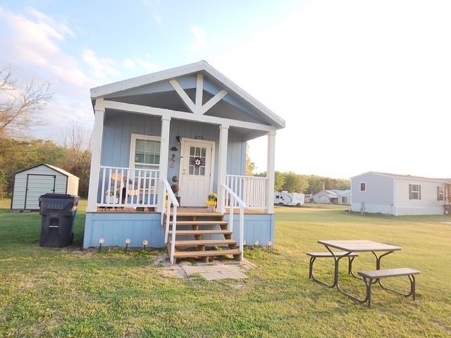1 Bedroom Tiny Home with electric Range,built in microwave, refrigerator. Walk in shower,double closets,stackable washer anddryer connections. Front porch for enjoying coffee and star gazing. Nice Storage Building is included. Sleeper Sofa can bepurchased seperately. Make your appointment today and start enjoying Lake Fork living. 2nd lot offers endless possibilities suchas play area, Carport, Boat storage or you could put RV or another home. Enjoy low maintenance for full or part time living. Shortand long term rentals allowed to use as investment property with small additional monthly HOA fee. NOW let's talk aboutAmenities of this Waterfront Gated Community on Legendary Lake Fork. HOA is $52. month which includes 2 Boat Ramps,Fishing Pier, Saltwater Swimming Pool, Picnic areas, sports courts, 4 private fishing ponds, something for all ages. Clubhousehas so much to offer, such as Cafe, weekly, monthly and special events, Bingo, Chair Yoga, Potluck meals, etc.