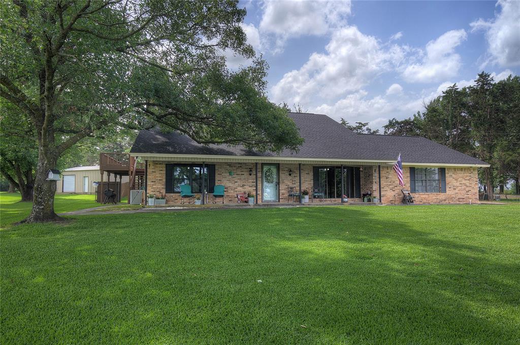 Welcome to Your 8.953 AG EXEMPT Acres of Space & Serenity~
Tucked away on nearly 9 ag-exempt acres, this all-electric beauty delivers the best of both worlds: a manicured and move-in-ready home with a gunite pool, and workshop- Wide-open Texas land ready for livestock, recreation, or simply breathing room.
The curb appeal sets the tone immediately - lush St. Augustine grass with an automatic sprinkler system, plus stately oak and magnolia trees frame the home. Step inside to a sweeping wooden curved staircase and brand-new LVP flooring. With 2,590 square feet of thoughtfully laid-out living space, there's room for everyone.
The kitchen is a true gathering hub — double wall oven, electric cooktop, island, dishwasher, breakfast nook, and a gorgeous bay window with built-in seating overlooking the sparkling pool. The living room features a wood-burning brick fireplace and built-in bookshelves. A formal dining room could double as a den or flex space.
Two primary suites — one on each floor — offer maximum flexibility. The upstairs suite includes a 12x9 office or nursery, ensuite bath with double vanity and walk-in closet, and direct access to a massive 27x10 heated & cooled sunroom with a private balcony deck over the pool. A third bedroom boasts its own wood-burning fireplace, plus a study nook with built-in shelves. Three full baths total.
Outside, a 16x32 Gunite pool with waterfall feature, tile edging, and concrete deck is enclosed by a privacy fence. A covered back porch makes poolside living effortless. The 300-foot well means no water bill! The utility room fits a full-size washer & dryer plus a freezer with abundant pantry shelving.
Beyond the home, ag-exempt, wire-fenced acres await — along with a 30x20 metal shop with electricity, roll-up doors, and a 30x16 covered overhang for equipment or boat storage.
Space. Privacy. Pool. Land. Workshop- and Starry skies at night! This one truly has it all. 5 min from I-30, 15 min to Lake Cypress, 100 mi to DFW.