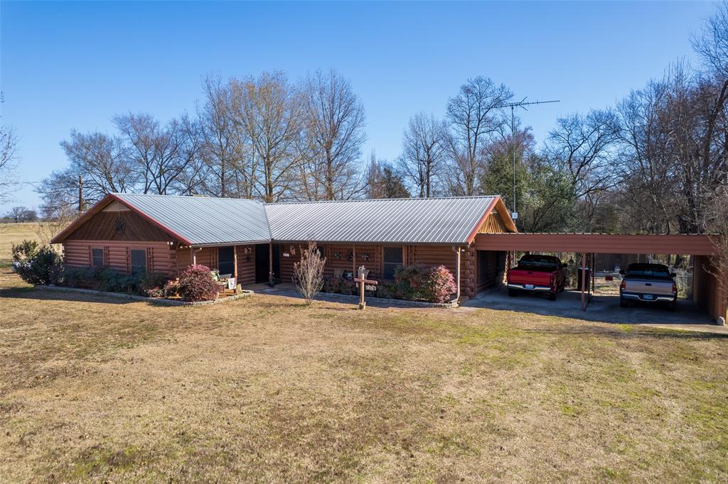 This could be the one you have been looking for...check out this 3 bedroom, 2 bath and 2 car carport Satterwhite log home on almost 2 acres between Mt. Vernon and Winnsboro and minutes from beautiful Lake Cypress Springs. The family room includes vaulted ceiling and large stone fireplace with gas logs. Real log siding throughout. The kitchen features an electric stove and cooktop, dishwasher and microwave. Large master bedroom suite with jetted garden tub and separate shower, two walk-in closets and double sinks. The additional bedrooms are both 12x12 so plenty of room for all your stuff. There is a large utility room and a sunroom across the entire back of the house. Worried about power outages?...Don't...this home includes a propane generator and propane logs for the fireplace. It also has an attic fan for fresh air on those mild spring and fall days and nights. For extra storage, there is an additional 12x24 storage building with covered outside storage on the back. Whether you are looking for your permanent home or weekend getaway, make the call and schedule your private showing today.
