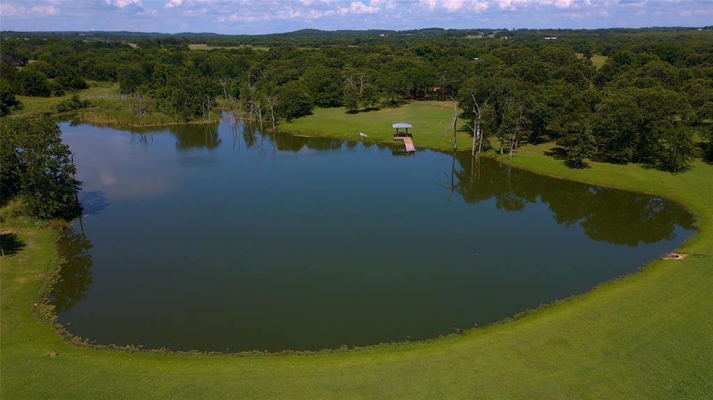 The ideal weekend family retreat, or forever home located in the post oak covered hills of southeastern Cooke County offers complete privacy while also being minutes away from town.  4 acre lake stocked with trophy bass, waterfowl habitat and a dock.  Ox Creek runs through the property with magnificent trees, excellent deer and turkey populations, and grass covered rolling hills make this the ultimate multi-purpose ranch.
Well-appointed rustic log cabin.  Could be used as a weekend getaway, primary residence, or even a venue for all kinds of events. Offered fully furnished. See full description in docs folder