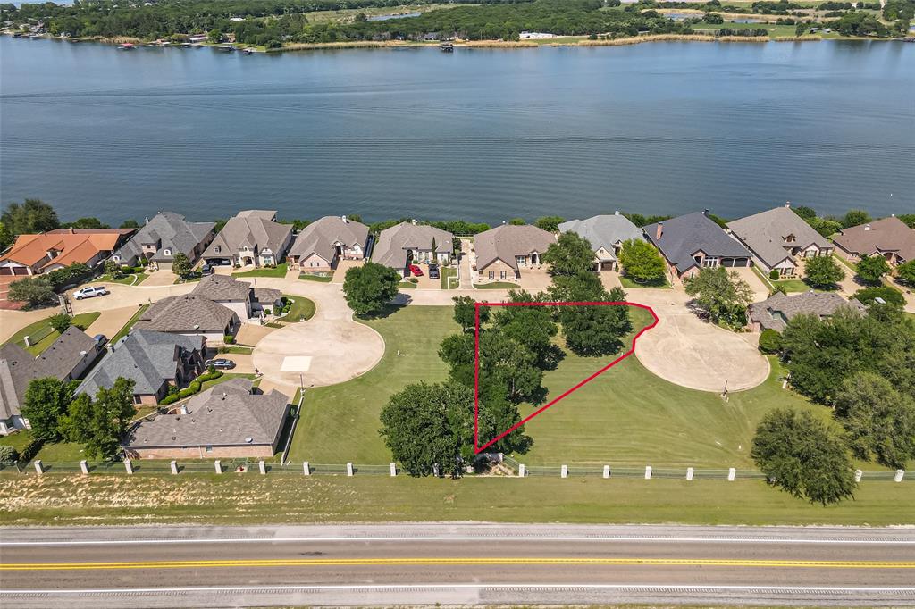 Nestled on a quiet cul-de-sac street within the prestigious gated Bluff View on Lake Granbury community, this generously sized 10,890 sq ft (0.25 acre) lot offers one of the most compelling build opportunities on Lake Granbury. Surrounded by mature trees and established custom homes, this parcel provides an exceptional canvas for a single-family custom residence in a neighborhood where quality and curb appeal are protected by thoughtfully crafted deed restrictions. AMUD water, sewer, and natural gas are available, streamlining the path from acquisition to construction. Community amenities include Lake Granbury access, marina slips, and scenic lakeside walking paths — all within a secure gated setting that today's relocation buyers actively seek. Just minutes from Granbury's vibrant Historic Square and approximately one hour from Fort Worth via US-377. Available individually or as a package with 4109 Bluff View Dr. Information deemed reliable but not guaranteed. Survey available. Utilities should be independently verified.