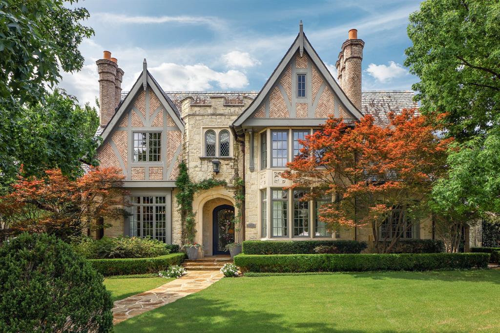 Celebrated by D Home as one of Dallas' 10 Most Beautiful Homes, this distinguished English Tudor commands one of the most coveted corner settings within Highland Park's storied French Streets neighborhood. Built by custom builder Jeff Gilbert and thoughtfully updated, the home blends timeless architecture, superior craftsmanship, and modern luxury. Spanning three levels connected by elevator, the home offers 6 beds, 6 full baths, and 3 powder baths. A gracious floor plan is designed for both elegant entertaining and everyday living, featuring formal living and dining rooms, a richly paneled study, all with fireplace, and a sophisticated butler’s pantry with wet bar and wine storage. The chef’s kitchen, breakfast area, and fireside sitting room flow seamlessly into the expansive family room, creating an ideal gathering space. Architectural details include 7 fireplaces, vaulted ceilings, custom millwork, Sonos sound system, and curated finishes throughout. The luxurious primary suite features a private sitting room with fireplace, spa-inspired bath, and separate his-and-her baths and closets. Four additional ensuite bedrooms and a spacious game room complete the second level. The third floor offers exceptional flexibility with a sixth bedroom suite, additional game room or apartment-style living area ideal for guests or multigenerational living, plus a bonus room for an office, crafts, or storage. Designed for indoor-outdoor living, walls of windows overlook beautifully landscaped grounds with a resort-style pool, covered terraces, outdoor living, and exterior lighting. The oversized 3-car garage accommodates 3 large SUVs and provides abundant storage. Ideally located within walking distance of Highland Park Village, Bradfield Elementary, and Dallas Country Club, this is a rare opportunity to own one of Highland Park’s most celebrated residences, where architectural beauty, exceptional design, and an irreplaceable location come together in extraordinary fashion.