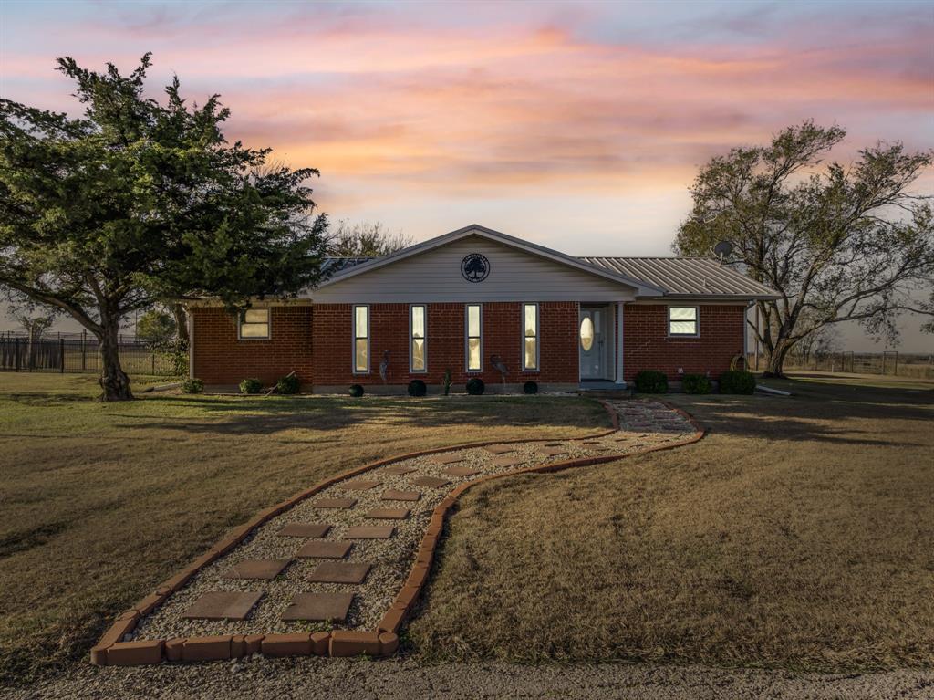 Welcome to this charming and beautifully maintained home situated on 2 peaceful acres. Originally built in 1973 and thoughtfully updated in 2014, this 2-bedroom, 2.5-bath residence blends classic character with comfortable modern living. Step inside to find a warm and inviting layout with generous living spaces — perfect for everyday living or hosting friends and family. The durable metal roof offers long-lasting protection and low-maintenance peace of mind, while the recently installed air conditioning system ensures year-round comfort. Outdoors, you’ll appreciate the two-car garage, additional carport parking, and a spacious workshop ideal for hobbies, storage, or projects. The corner-lot setting provides an open, country feel with plenty of room to relax, garden, work, or play. Enjoy the best of both worlds — peaceful country living just minutes from town. With its expansive acreage, versatile outbuildings, and timeless charm, this property offers space to grow and a wonderful place to call home.
