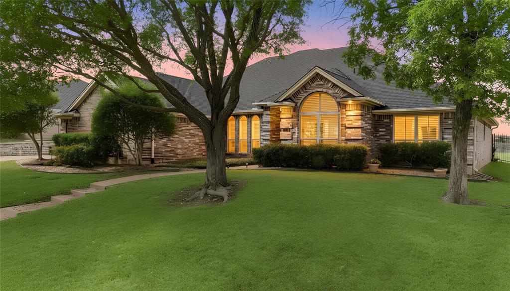Welcome to this beautifully maintained custom home nestled on a premium oversized lot in the highly desirable Lost Creek Hollow subdivision.  With 2919 square feet, this 4-bedroom, 3.5-bath residence offers privacy, breathtaking views of rolling hills, and land that was previously part of the Lost Creek Hollow Golf Club, and currently provides tons of greenbelt spaces throughout the neighborhood to enjoy. Built in 2000 by custom builder William Horn, this all-electric home blends timeless craftsmanship with major recent updates. The seller has invested heavily in improvements including all new windows & new LVT Flooring in the Guest Suite in 2025, A new roof & new gutters in May 2024. The HVAC system was serviced (Oct 2025, including a new 5-ton condenser and all filters were replaced. Three 50-gallon hot water heaters recently replaced, 2025, 2024 & 2010 (All have pans and alarms), offering efficiency and peace of mind.The oversized 3-car garage provides ample storage and parking. (Garage Doors were serviced June 2025..
A whole-home generator powered by propane and serviced annually conveys with the property, along with the security system and cameras.
Inside, you’ll find custom plantation shutters throughout,  spacious living areas  and thoughtful design elements that make this home both functional and inviting.  A fabulous private suite or flex room w private entry, sink, refrigerator & curbless shower provides many options: guest suite, gameroom, additional bedroom, multi-gen etc...Convenient kitchen w beautiful granite Countertops Island and a HUGE  walk-in pantry Enjoy serene views, generous space, and the quiet charm of Lost Creek Hollow — Located Conveniently Between Ft Worth & Aledo with Fort Worth ISD.
This is Texas Living!