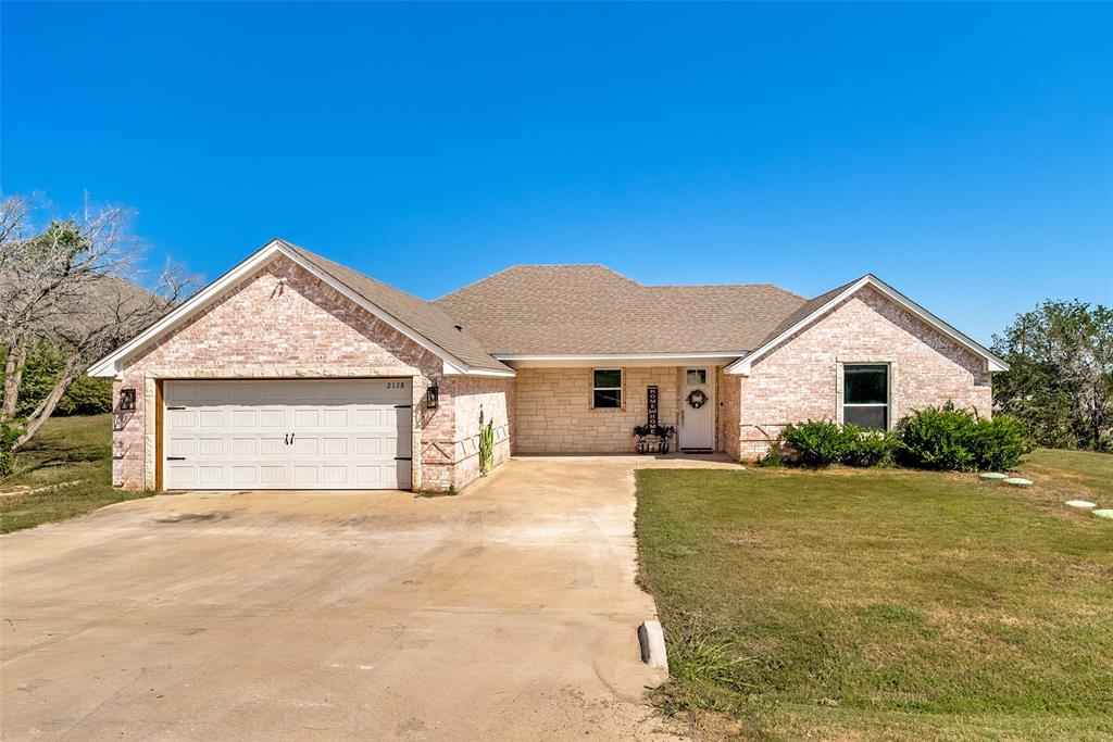 Beautifully maintained home in a gated lake subdivision. 3-bed, 2 bath with an open concept layout that blends comfort, style, and privacy. Wall-to-wall windows fill the home with natural light while overlooking peaceful green space with no immediate rear neighbors. The stunning kitchen features granite countertops, a large center island, abundant cabinetry, and opens seamlessly to the living and dining areas- perfect for everyday living and entertaining! The spacious primary suite offers a custom wood tray ceiling and a spa- like ensuite bath. Additional highlights include generously sized secondary bedrooms, an oversized utility room with built in cabinetry, crown molding, upgraded finishes, and tile flooring through the main living areas. This home truly checks all the boxes.
