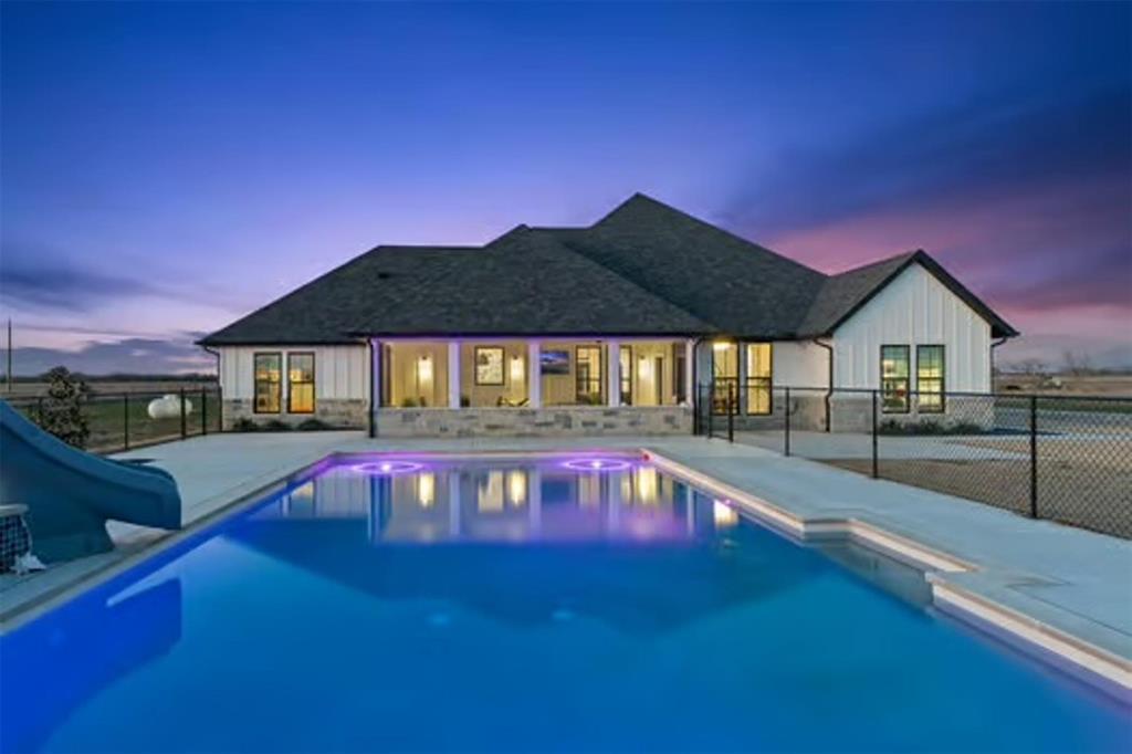 This modern farmhouse sits on 9.66 acres in Caddo Mills and offers the kind of space and flexibility that’s getting harder to find. With 4 bedrooms, 3 bathrooms, a dedicated office, and an upstairs bonus room with a full bath, the layout works for a variety of needs, whether that’s hosting guests, working from home, or creating a separate space for hobbies or a game room. The main living area is open and inviting, with a kitchen that flows easily into the living room, making it ideal for everyday living and entertaining. A sunroom off the back of the home brings in natural light and gives you a place to slow down and take in the views of the property.

Outside is where this property really stands out. You have a resort-style pool with a tanning ledge and LED lighting, a stocked pond, and wide-open acreage that gives you room to spread out and make it your own. Whether you’ve been looking for space for animals, a place to add a shop, or just want privacy and quiet without being too far out, this property checks those boxes. The gated entry adds an extra layer of privacy, and you’re still within a convenient drive to town and major highways, so you’re not sacrificing accessibility for space.

Properties like this offer a balance that’s hard to find, modern construction with land, functional living space, and the ability to truly use your property the way you want. If you’ve been searching for acreage with a pool, pond, room to grow and ag exempt, this is one worth seeing in person.