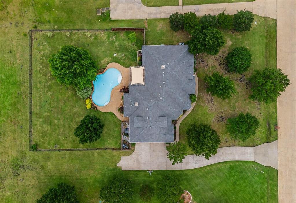 ***OPEN HOUSE CX DUE TO RAIN***POOL, PRIVACY & ACREAGE ALL IN ONE! Nestled on a beautifully landscaped 1.15+-acre lot in sought-after Shamrock Ridge, this extensively updated home offers the space, flexibility, and outdoor living that are becoming increasingly difficult to find. Mature trees, a sparkling pool, covered outdoor entertaining area, and expansive backyard create the perfect setting for relaxing, entertaining, and enjoying the best of Texas living.

Inside, rich wood flooring, extensive crown molding, multiple living and dining areas, and an open, inviting layout create a warm yet elegant atmosphere. The spacious kitchen features granite countertops, stainless appliances, abundant cabinetry, and a large island that opens seamlessly to the main living area with fireplace and custom built-ins. The private primary suite is a true retreat, highlighted by a see-through fireplace and a beautifully remodeled spa-inspired bath featuring a freestanding soaking tub, oversized walk-in shower, dual vanities, and designer finishes.

Offering 4 bedrooms, 2.5 baths, an oversized upstairs game room or media room, and a 3-car garage, this home provides exceptional flexibility for growing families, guests, hobbies, or working from home. Outside, you'll find the kind of backyard that is rarely available today, with room to spread out, entertain, play, and enjoy the peaceful setting of one of Forney's premier acreage communities. Combining over an acre of land, a resort-style pool, thoughtful updates, and a prime location, this is a rare opportunity to enjoy space, comfort, and convenience all in one property.