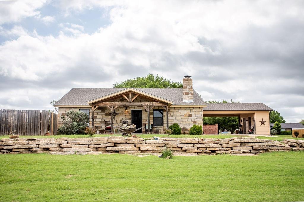 Discover this stunning 3-bedroom, 2-bath home with an open-concept floor plan, a rustic-elegant style, and just over 2000 square feet. Enjoy the impressive 14-foot ceilings, gorgeous wood beams, and a floor-to-ceiling fireplace that creates a cozy, inviting atmosphere. The home features brand-new appliances, a 3-year-old, 4-star shingled roof, and a freshly painted interior and exterior.
Outdoors, you'll find a drive-through Porte cochere with easy access to the home and additional storage space. The backyard oasis features an above-ground pool surrounded by a wraparound deck and an outdoor kitchen area, perfect for relaxing or entertaining. The pool has new liner and pump. It also includes a 30-amp hookup, RV space, and an extra lot, making this a must see property.    Call Clear Fork Realty today to schedule your showing!