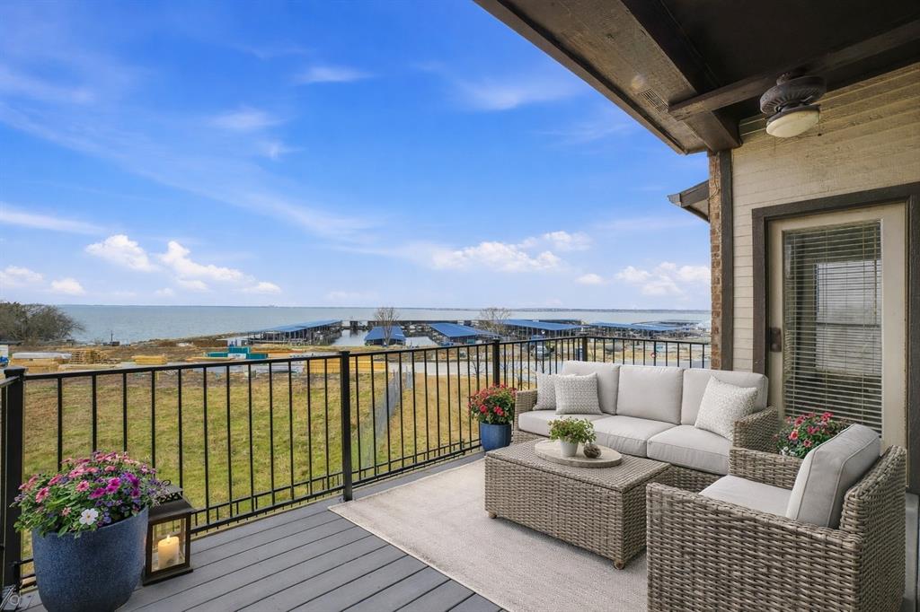 Experience effortless lakeside living in this beautifully positioned corner-unit condo in the desirable Spyglass Hill community of Rockwall. Perfectly situated to capture stunning west-facing views, this light-filled 2-bedroom, 2-bath residence offers 1,174 square feet of thoughtfully designed single-level living. The spacious living room welcomes you with a striking marble wood-burning fireplace, decorative lighting, and seamless access to the 9’ x 15’ private balcony—an ideal setting to unwind and enjoy vibrant sunsets through the sliding glass doors. The kitchen features unique cork flooring, solid surface countertops, built-in cabinetry, a breakfast bar, and a 27 cu ft refrigerator, creating a functional and inviting space for everyday living. Both bedrooms are generously sized with ensuite baths and walk-in closets, including a well-appointed primary suite highlighted by a spa-inspired walk-in shower with body sprays. Washer and dryer hookups add everyday convenience, and recent attic insulation improvements have enhanced energy efficiency, reducing electric costs by 20% or more. With assigned parking, community-maintained grounds, and a prime location near the lake, dining, and shopping, this corner-unit condo combines comfort, efficiency, and scenic charm in one exceptional offering. Luxury Townhomes are under construction on the adjacent property which will likely sell above 500k. This could possibly raise the nearby property values substantially.  Unit 275 will be one of the few condos that will retain a partial lake view. Within walking distance to lake and chandler’s landing marina, get home from work at 5:30 and be on your boat by 5:45!! Boat clubs and boat rentals also available. Some photos are virtually staged.