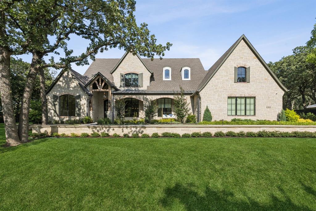Discover luxury living in this stunning Lorant and Elliott Estate Homes MASTERPIECE on over 1 acre in Southlake. This 5,879 sq ft treasure showcases impeccable craftsmanship with European white oak floors, designer shades, lighting, and natural stone throughout. The gourmet kitchen features an oversized Taj Mahal island, complete Thermador appliance suite including a 6 burner gas range with griddle, vent hood, double ovens, and is adjacent to the butler's pantry. The open concept flows seamlessly to the family room with custom wood beams and floor-to-ceiling stacked stone fireplace. Four bedrooms include a lavish primary suite with sitting area, motorized shades, custom fireplace, Hollywood soaking tub, and walk-in shower. Two studies and entertainment areas with wet bars offer versatile spaces. Resort-style outdoor living awaits with sparkling pool and spa, covered patio featuring outdoor kitchen, gas grill, and cozy fireplace. Exemplary Carroll ISD. Every detail reflects sophisticated elegance in this extraordinary home where luxury meets lifestyle!