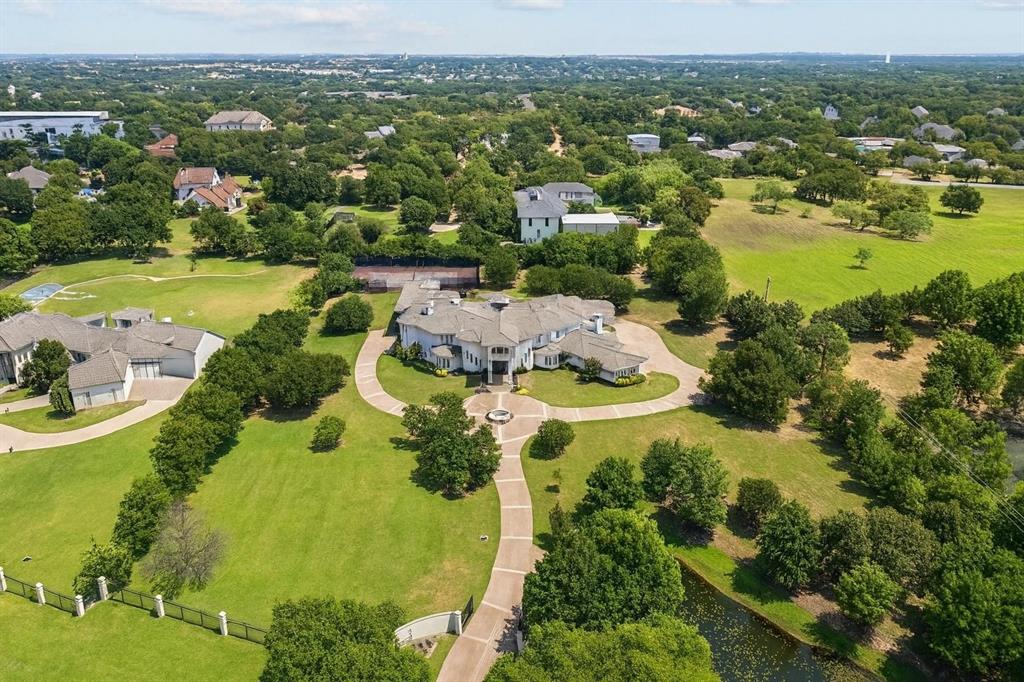 Nestled on the highly coveted White Chapel Boulevard, this exquisite gated estate offers an unparalleled blend of luxury, privacy, and recreation on nearly 4 acres! Designed with meticulous attention to detail, the home features a private pond, indoor basketball-sport court, and an outdoor tennis court—perfect for both relaxation and activity.

Inside, custom features abound, including elegant spiral staircases, tranquil fountains, and a dramatic wall of windows that frame views of the pool and expansive outdoor living space. The open-concept living area flows seamlessly into a warm, inviting kitchen and spacious game room, ideal for entertaining guests or hosting large gatherings.

Additional highlights include three separate garages, a cabana with a built-in grill, and a generously sized yet secluded yard. This property is a rare opportunity to own a truly unique estate in one of the area's most sought-after locations.