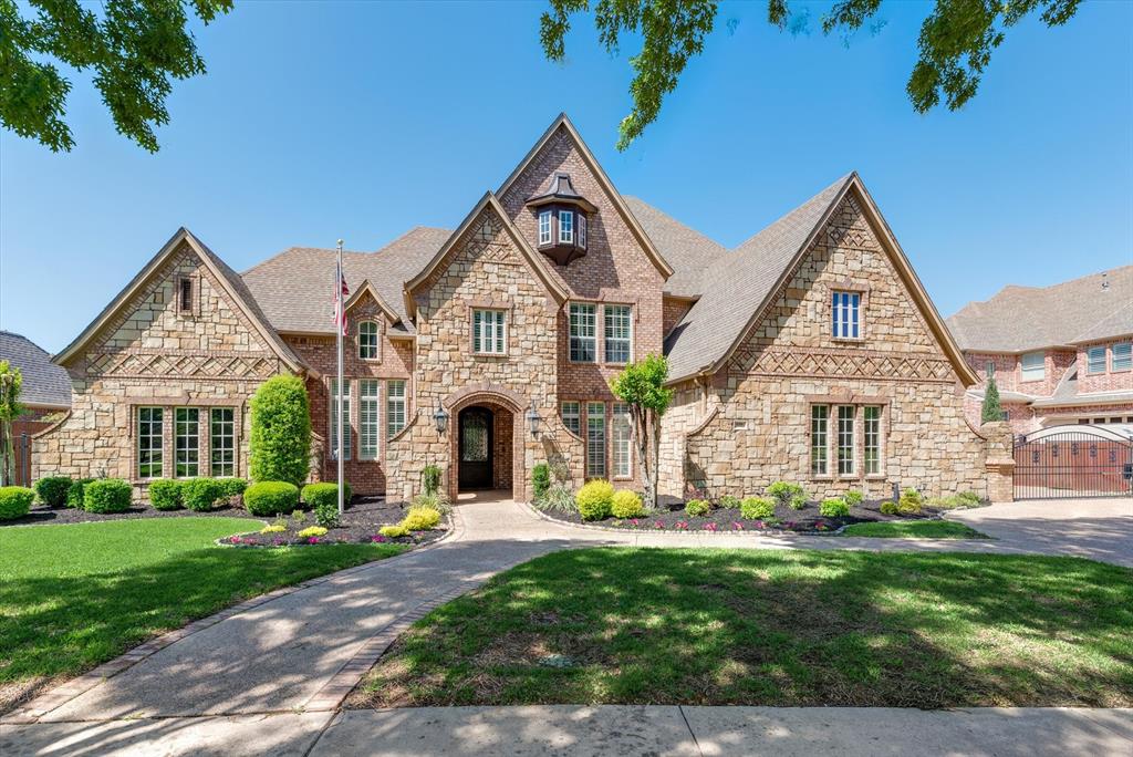 Stunning stately home on manicured grounds in Southlake's Estes Park. This Starwood Homes custom build has been beautifully updated since! Oversized iron door draws you into the grand entry with soaring ceilings, flanked by an executive study, striking formals adorned with hardwoods & custom craftsmanship. Climate-controlled wine cellar, butler's pantry & mud room. Gourmet kitchen with 2 vast islands, Thermador appliances, quartzite tops & open to breakfast area with office nook & den. Lavish primary suite with sitting room, coffee bar & spa-like bath with freestanding tub, walk-in shower & dual vanities. 1st floor guest suite. Upstairs, game room with wet bar & media, 3 bedrooms with ensuite baths & study nook. Escape to the backyard retreat, cook, dine & unwind under the covered patios, swim in the pool & spa, or head over for a round of bocce ball! 4 garages & new carpet! Enjoy the adjacent park, award-winning schools, or all the shopping, dining & entertainment Southlake offers!