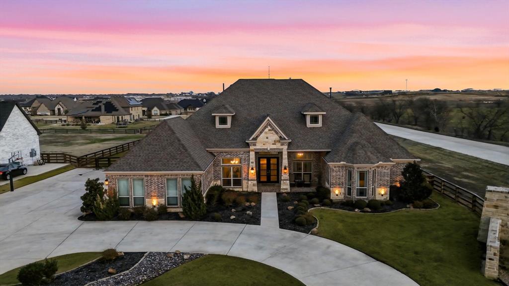 Welcome to 7751 Faught Road in Northlake, Texas, a beautifully designed 4-bedroom, 5-bathroom custom home offering 4,324 square feet, located in highly sought-after Argyle ISD. Built in 2017 and situated on a full one-acre homesite this one-story custom home offers the perfect balance of privacy, space and modern luxury, inside the quaint neighborhood of Creek Meadows. Inside, you'll find an inviting open layout with abundant natural light- from the floor to ceiling windows and sliding glass patio doors- and functional living spaces, designed for both everyday living and entertaining. The kitchen is a chef's dream with top of the line appliances and enormous island, perfect for gathering. Featuring a dedicated office ideal for working from home and a formal dining room, perfect for hosting friends and family! The true showstopper is the backyard paradise! Enjoy your gorgeous pool with connected spa, surrounded by expansive decking, accented with fire bowls, a fire pit and a fireplace seating area perfect for relaxing evenings. An outdoor shower provides convenience and luxury. The detached pool house features a half bathroom and a dry sauna with a volcanic rock heater providing proven health benefits and creating an elevated private retreat ideal for guests and year-round enjoyment. The four car garage has room for all your cars and toys and is equipped with EV charging outlets. With room to breathe, resort-style outdoor living and access to shopping dining and major highways, this property delivers lifestyle, comfort and convenience all in one!