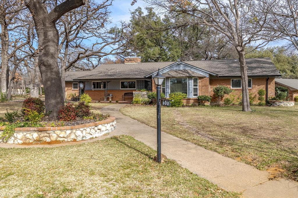 STOP! See the price improvement! Hurry to see this classic 1950s home situated on a corner lot beneath a large, mature tree canopy. This inviting residence features three distinct living areas, including a beautiful Four Seasons garden room overlooking the spacious backyard. An oversized garage provides generous storage along with a dedicated workshop area.

Designed for entertaining, the home offers excellent guest flow throughout. The enclosed sunroom and utility area add approximately 290 additional square feet, enhancing both functionality and versatility. Abundant windows fill the home with natural light while providing pleasant views in every direction, creating a bright and welcoming atmosphere.