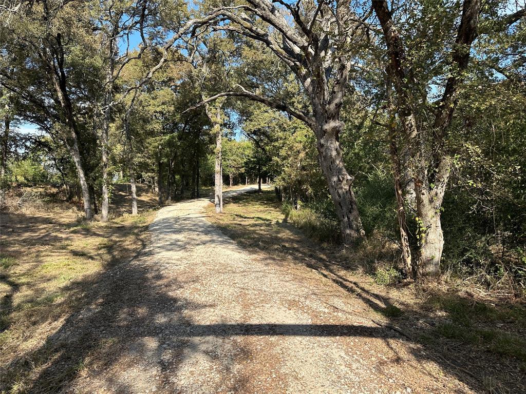 Discover a rare gem nestled in the heart of East Texas, where natural beauty meets exceptional convenience! This expansive vacant land offers the perfect canvas for your dream project, whether you envision a stunning residential development or your own private estate retreat.  The property showcases nature's finest artistry with magnificent hardwood trees scattered throughout, creating a park-like atmosphere that's both serene and inspiring. Multiple ponds dot the landscape, adding tranquil water features that enhance the property's natural charm and provide excellent recreational opportunities. Well-established trails wind through the terrain, perfect for hiking, horseback riding, or simply enjoying peaceful walks among the towering trees. What makes this land truly special is its remarkable combination of rural tranquility and urban accessibility. Located within minutes of Interstate 30, you'll enjoy the best of both worlds – countryside living with easy access to major transportation corridors. The proximity to Dallas, just an hour's drive away, makes this an ideal location for those seeking a peaceful retreat without sacrificing convenience. The diverse topography includes beautiful open pasture areas alongside wooded sections, offering flexibility for various development possibilities. Some floodplain areas add to the natural ecosystem, supporting local wildlife and maintaining the property's authentic rural character. Multiple potential home sites throughout the acreage provide options for creating your perfect sanctuary.  This unique property represents an exceptional opportunity to own a piece of Texas countryside with development potential, recreational amenities, and unmatched convenience. The combination of natural hardwoods, water features, and strategic location creates endless possibilities for investors, developers, or anyone seeking their own slice of rural paradise.