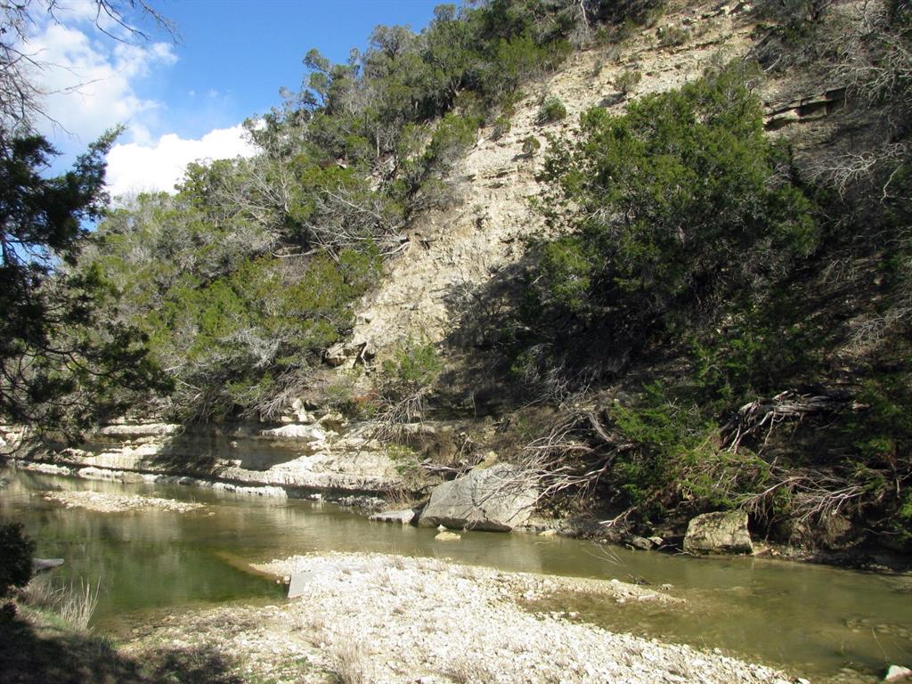 This 5.01-acre tract is located in the gated Buffalo Creek Subdivision, known as lot 62, offers a peaceful setting with paved roads, rolling terrain, and a mix of mature trees. The property features frontage along Langford Creek, providing a scenic and serene backdrop ideal for a homesite or weekend retreat. Electricity and high-speed fiber optic internet are available, and a private water well will need to be drilled. Centrally located, this property is just 30 minutes from Hamilton, Lampasas, and Gatesville, and about an hour from Waco and Stephenville, making it a convenient escape with easy access to surrounding towns. Whether you're looking to build your dream home or invest in land with natural beauty and modern infrastructure, this property presents an excellent opportunity in a well-maintained rural community.