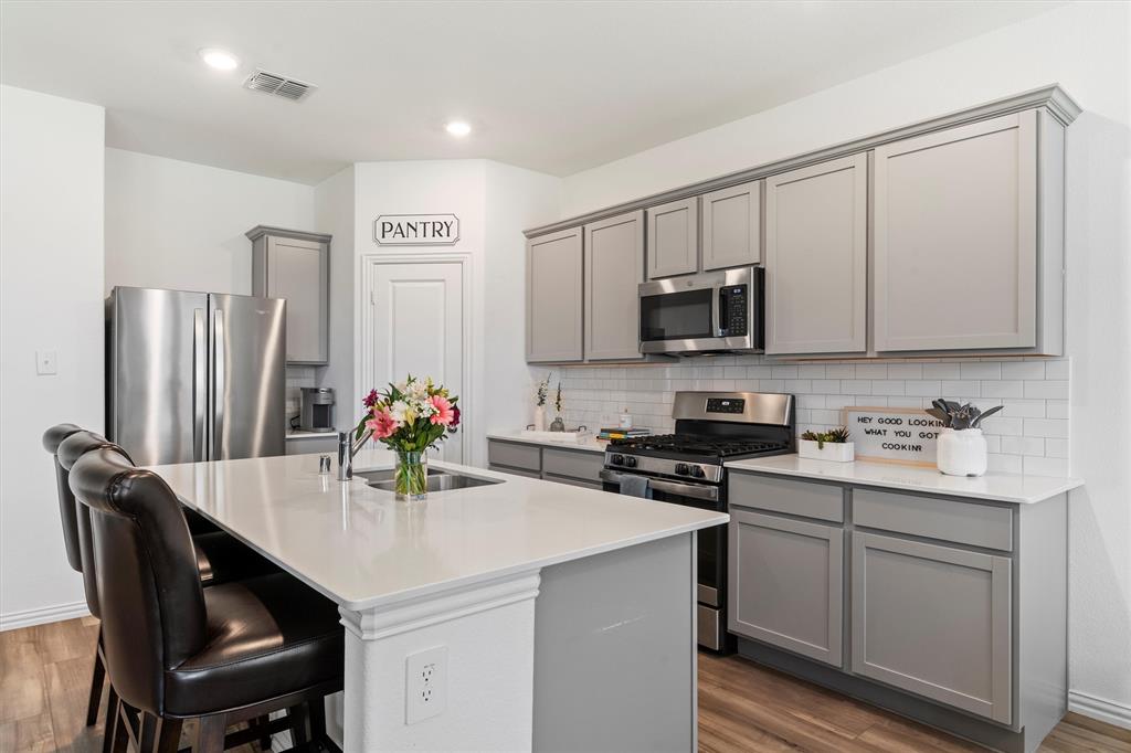 Nestled on a corner lot in a cul-de-sac, this charming 3-bedroom, 2-bathroom home offers the perfect balance of comfort and convenience in the Trinity Crossing community. The open floor plan and tall ceilings create a bright, airy feel, seamlessly connecting the main living areas for everyday living and entertaining. The kitchen features white quartz countertops, stainless steel appliances, and a walk-in pantry. The spacious primary suite includes an ensuite bath with a double-sink vanity and a generous walk-in closet. Two additional bedrooms at the front of the home share a full bath—ideal for family, guests, or an office. Step outside to a large backyard with a covered patio, perfect for grilling, relaxing, or watching TV outdoors. Enjoy access to the neighborhood pool and playground by strolling over during the summer. With quick access to Highway 80, Lake Ray Hubbard, the Mesquite Airport, and a variety of shopping, dining, and entertainment options, you'll love the lifestyle this home offers. Plus, it qualifies for the USDA loan program—ask your lender about 0% down options!