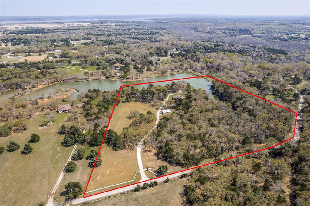 Private 15.75-acre lakeside retreat offering panoramic water views and exceptional privacy in a secluded area with paved roads and no through traffic. The home is located at the end of a long drive, and the property offers a rare combination of open pasture, wooded acreage, and access to a stocked private lake shared with only four neighbors. The home is well-maintained, beautifully updated, and positioned to capture your own private, serene lake, wooded areas, and wildlife views while still being close to Lake Texoma boating and fishing opportunities. Outdoor amenities include an oversized 2-car detached garage, a large shop with multiple 220V outlets, a tack barn, and a loafing shed with two kennels. Recent improvements include replacing the septic system (Feb 2026) and roof (Apr 2023), including gutters with leaf screens. Enjoy peaceful country living with modern conveniences, including GCEC electric, NW Grayson Water District water, and available fiber internet. Conveniently located minutes from Whitesboro, Rock Creek Golf Club, Lake Texoma, and approximately 25 minutes from Sherman. Need more space? Seller will consider offers on three adjacent parcels not included in this listing (9.57, 11.46, and 6.16 acres), offering the opportunity to assemble a contiguous 42.91-acre estate. All information is deemed reliable but not guaranteed; buyer and buyer’s agent to verify all information, including AG continuance.