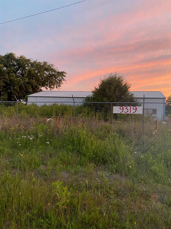 Nine+ acres fronting  SH 287 just outside Alvord city limits in county with no city fees, zoning or permits required.  With approximately 165 ft. of road frontage,TXDOT cutout from SH 287 and entry gate in place this property is easily accessible for whatever you chose to do.  It currently has a 20X50 Metal shop structure on concrete foundation that has lights and HVAC in place. (electric off so none of equipment has been recently tested) Building also is plumbed for half bath but nether well or sepctic have been installed. Building was used to store owners personal property. There are 2 Quonset huts one on concrete slab and one has gravel base. Two of the buildings are inside a chain link fence and are on concrete pads.  Front part of property currently has fencing on 3 sides and open to neighbors to north who are running cattle on front portion of both properties.  The property continues beyond back fence where there are native grasses and trees. Though no restructions or zoning this property is ideally set up to use front portion  commercially and back for residence but sky is the limit as to what works best for you.   See tax map in docs for property configuration. No current survey. Seller is continuing to remove things from property but would like to negotiate a lease-back to facilitate whatever remains at time of purchcase.