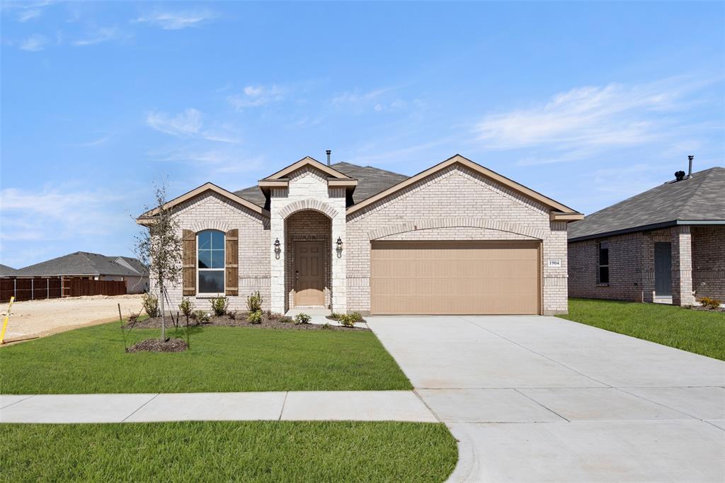 MLS# 20832505 - Built by Sandlin Homes - Ready Now! ~ Our Sterling plan with 4 bedrooms, 2 bathrooms, a fireplace in the living room, walk-in shower and bathtub in the owners bathroom, and a covered patio. This home is designed with our standard package including 3cm granite countertops, stained cabinets, tiled fireplace, carpet and tile flooring!