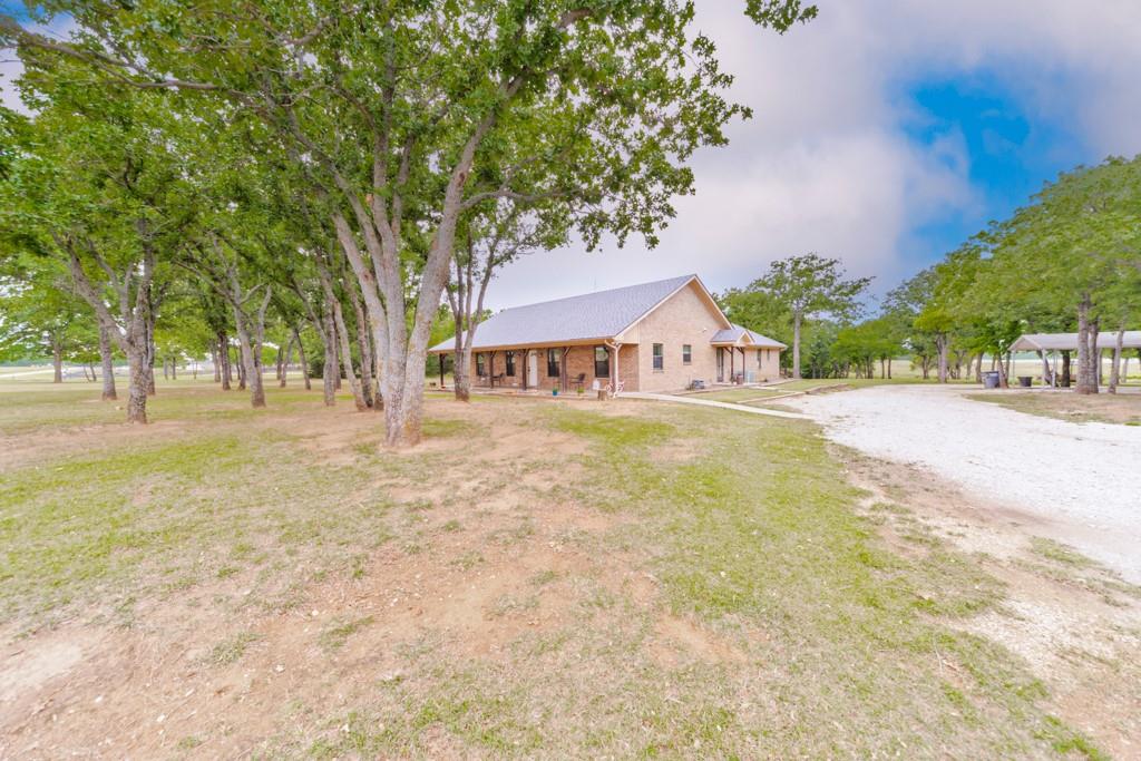 Summer Nights, Backyard cookouts, and Fourth of July Memories waiting to be made_ This charming brick 3 bedroom , 2 bath home was built for enjoying life outdoors. Sitting on a large 3 acre lot with nearby lake views. This property offers the perfect setup for gathering with the family and friends all season long. The spacious back porch with a pergola is ready for evenings spent grilling and watching kids play or just winding down under the string lights. Inside, the home features a comfortable layout with the dedicated office space that can serve as a fourth bedroom and a warm, welcoming feel throughout. The kitchen has a large granite covered island that opens into the spacious living room. The main bedroom features a nice spacious bath that includes a walk-in closet and an oversized shower. It also is blessed with a paved road and Wise electric to complete the near perfection that this house encapsulates. Other outside features include a tree house fort, while the firepit is waiting for you to make new memories.