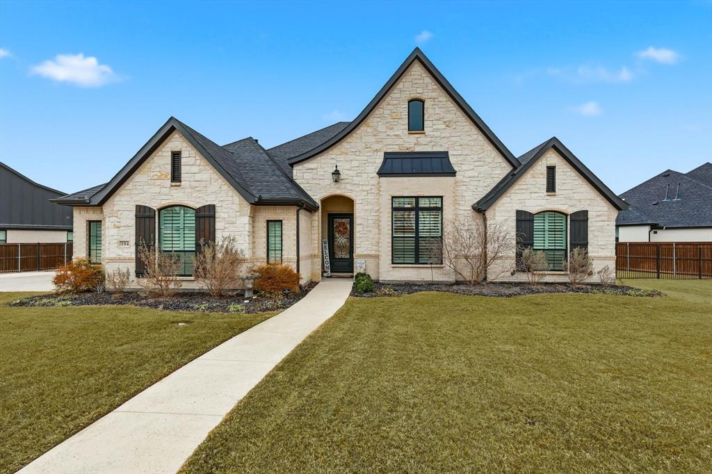 Stunning one-story modern farmhouse showcasing refined luxury and thoughtful design throughout. The expansive open floor plan is anchored by an incredible chef's kitchen featuring a statement oversized island, premium appliances, custom cabinetry and elegant coffee bar, ideal for entertaining and everyday living. Incredible wet bar and butler's pantry with lots of built-in storage, sink and drink refrigerator. Rich wood floors lead through to beautifully appointed living area with lovely fireplace and private study. The home offers 5 spacious bedrooms, including a truly private and luxurious primary suite with spa-inspired bath, upscale finishes, and a serene retreat feel. Incredible laundry room leads directly to primary closet for ultimate convenience, lots of extra storage and room for second refrigerator. This fantastic layout offers so many perks including exceptional storage throughout. Designer lighting, curated finishes and sophisticated decorator touches elevate every space, creating a perfect balance of warmth, comfort and high-end style. Lovely yard with large, covered patio, perfect to enjoy family fun.