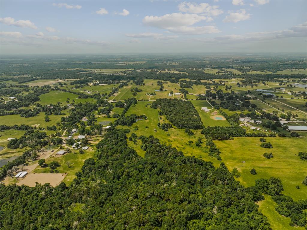 Exceptional location less than 1 mile from the beloved Texas Zoofari Park attraction and 22 miles from Canton Trade Days, this extraordinary 47.26 acre property offers a rare opportunity to create something deeply special. Framed by panoramic open skies, treed views and a peaceful pond setting as if lifted from the pages of a magazine, you’ll find winding grapevines draped along the fencing & countless picturesque spots to build. This land invites buyers to dream beyond what currently exists and imagine the legacy that could take shape here for generations to come. With a current wildlife AG exemption for lower taxes already in place, the property presents both value & potential in one remarkable setting with over 870 feet of FM 429 frontage, outside city limits with no HOA. The property features an existing home & barn that are currently considered the only structures safe to enter. Several additional buildings remain on the property but are unusable & considered to have little to no contributory value. Here, the true beauty & value lies within the land itself, the privacy, flexibility, natural setting & the endless possibilities spread across Kaufman county acreage. Whether envisioning a private homestead, an equestrian retreat, a destination Airbnb, boutique bed & breakfast, weekend escape, hunting property, family compound or simply a place to stretch out & enjoy the quiet beauty of nature, this property offers the canvas to bring that vision to life! The existing home could serve as a functional starting point while future plans unfold. The property is being sold AS-IS. Please use caution when walking the property- Signs will be posted on main buildings not accessible. *This is Private Property-Showings will need to be scheduled directly with the listing agent to enter & access property.* The kind of property that rarely becomes available, where the value is found not only in the land & location, but in the dreams & future waiting to be created.
