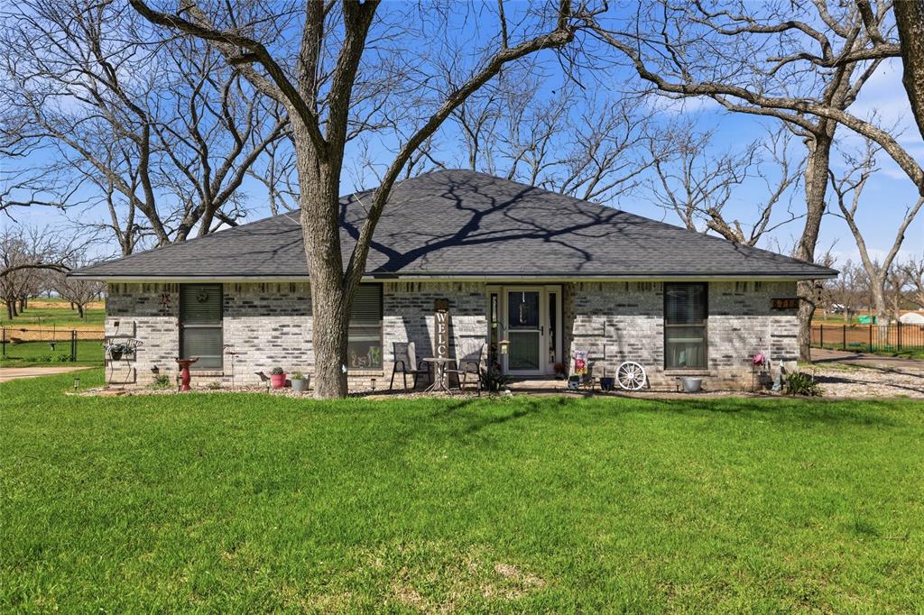 Discover your slice of paradise in the highly sought after Pecan Plantation community.  This charming single story traditional home offers 3 full bedrooms and an office or 4th bedroom space and two full bathrooms.  Comfortable living space and a lovely sunroom.  You'll find thoughtful updates, including a refreshed kitchen, newer flooring and other personal artistic touches throughout.  A stand out feature is the air conditioned attic space above the living room-perfect for extra storage.  The bright sunroom, accessible from both the living area and the primary provides a serene spot to relax year round.  Step outside to enjoy the beautiful backyard surrounded by the pecan orchard and watch the deer and wildlife as they lounge under the trees.  This home has a recent septic system installed in 2020 and a roof installed in 2022.  Pecan Plantation is a resort style community nestled along the Brazos River, offering incredible array of amenities: golf courses, tennis and pickleball, swimming pools, marina with boat ramp, slips, walking trails parks, activity center, archery range and even private aviation airparks.  Don't miss your chance to get in at a great price  $3000 Buyer incentive offered.