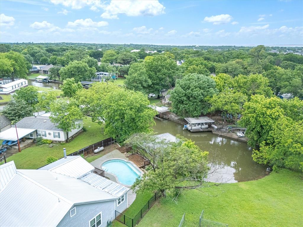 SPECTACULAR LAKE GRANBURY RETREAT! Seize the opportunity to own this remarkable property, the perfect summer escape or an exceptional Airbnb investment! As you enter your dream getaway, you’ll be captivated by the thoughtful renovations throughout, featuring brand new carpet and a fresh coat of paint. This stunning home boasts two luxurious master suites on the main floor, each equipped with elegant bathrooms and spacious walk-in closets for ultimate comfort. An inviting office space located just off one of the master suites offers an ideal setting for remote work or quiet study sessions. 

Venture up the private staircase to discover a delightful third bedroom, perfect for guests or family. The beautifully designed kitchen is a chef's dream, featuring granite countertops and stainless steel appliances, all overlooking the expansive living area complete with a cozy wood-burning fireplace. Get ready to entertain friends and family on the ample outdoor patio, or unwind by the sparkling pool while soaking up the warm Texas sunshine. Boating enthusiasts will love the exclusive access to Lake Granbury right from your own backyard! Don’t let this incredible opportunity pass you by!