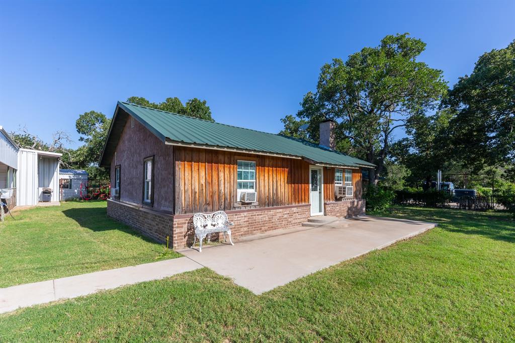 Welcome to this 4 bedroom, 2 bathroom country property sitting on 5 beautiful acres in Clyde, Texas. This property is perfectly set up for the  livestock enthusiast, hobby farmer, or anyone ready to embrace the West Texas rural lifestyle. The home features a warm and inviting living area with a cozy fireplace and a dedicated dining room ideal for family gatherings after a long day. Outside is where this place truly shines. The entire property is fenced and cross fenced with net wire fencing designed for all of your livestock needs.  It has successfully housed sheep, goats, show cattle, and horses. A fenced front yard and fenced back yard provide added privacy and functionality for everyday living. The improvements are impressive and ready to work. A 36 x 36 barn with 6 stalls, 3 with turn out pens and 3 smaller stalls inside the barn. A dedicated arena and round pen make this property a dream for horse enthusiasts. A 20 x 30 run in shed provides additional covered shelter for animals. A 25 x 17 workshop with 2 roll-up doors and a man door is perfect for equipment, projects, and storage. A 15 x 25 RV and carport offers covered parking for your larger vehicles and equipment. A sea container provides additional secure storage. A gravel pad offers extra parking for trailers, trucks, and guests. The home is serviced by Callahan County Water. A working water well located in the well house services the yard and provides water for the animals.  This is a rare opportunity to own a truly functional rural property in Clyde ISD with the infrastructure already in place to hit the ground running.