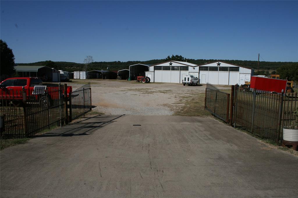 If you are looking for property that will produce money making investments, then you have found it. The north section has several warehouses, office space with two entrances, and lots of storage. The South section has three apparent sized living spaces, carports for rent or parking, and an additional ambulance service building that is rented out. There is also a large billboard that is producing income. The approximate 7,000.00 rent per month is differently a plus. You have a front entrance off of Hwy 180 and a rear entrance off of Bankhead Hwy, You can continue the rental business or have several businesses doing business out of the 4.5 acres with two entrances. You are less than two minutes from the hospital, and about five minutes to downtown Mineral Wells.
