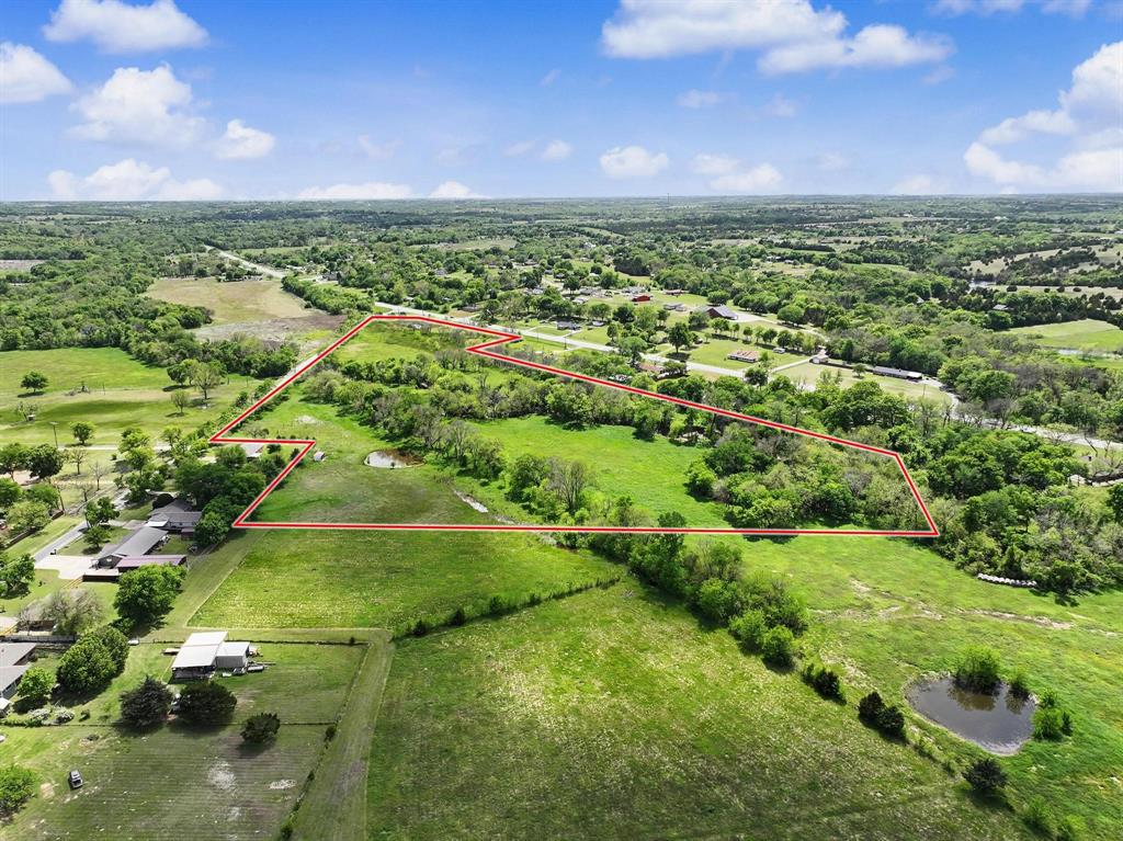22 Scenic Acres with Pond, Mature Trees & AG Exemption Near Sherman!** This beautiful 22-acre tract offers a rare combination of natural beauty, privacy, and accessibility in one of North Texas' fastest-growing areas. Located off Watkins Road near Hwy 11, the property features a picturesque pond, abundant mature tree coverage, and an existing agricultural exemption.

The diverse landscape provides excellent wildlife habitat, scenic views, and plenty of open space, making it well-suited for agricultural, recreational, conservation, or investment purposes. With road frontage and convenient access, you'll enjoy a peaceful rural setting while remaining just 10 minutes from US 75 and Sherman’s expanding commercial and employment corridors.

Large tracts with this level of tree coverage, water features, and strategic location are becoming increasingly difficult to find. Survey with floodplain information is available. Don't miss this opportunity to own a distinctive piece of Grayson County acreage with exceptional long-term potential.