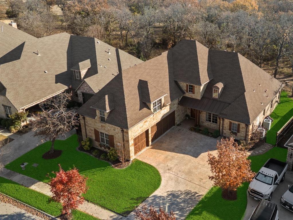 Welcome home to 304 Boonesville Bend! Nestled in a private enclave of Argyle, this exceptional custom home offers both privacy and convenience. Situated across the street from a beautiful wooded park and backing to heavily treed acreage adds to the uniqueness and charm of this beautiful home.  The partially gated community ensures a secure and serene environment, perfect for family living.  As you enter, you're greeted by an inviting study with a gorgeous park view, beautifully designed stairway and a spacious open-concept kitchen and family room, ideal for both entertaining and everyday relaxation. The kitchen features beautiful finishes, a large island, a well designed buffet wall to feature all of your prized dishes and a walk-in pantry, making meal prep a breeze. Adjacent to the family room is a cozy, private master retreat, designed for ultimate comfort and relaxation. This sanctuary includes a generous en-suite bathroom with dual vanities, separate shower and spacious walk in closet. The home's large laundry room and additional storage spaces, including a walk-in pantry, make organization simple and convenient.  Upstairs, you'll find two spacious bedrooms, a large game room, and a flexible bonus room that can serve as a nursery, additional office, or even a kids' bunk room. This versatile space ensures that the home adapts to your needs as they evolve.  The oversized 3-car garage provides ample space for vehicles, tools, and outdoor gear. For outdoor enthusiasts, the cozy covered back patio features a built-in grill and fireplace, offering an inviting space for gatherings or quiet evenings spent enjoying the peaceful surroundings. This home combines thoughtful design, functional spaces, and a prime location with a short walk to the middle school, offering a perfect balance of luxury and everyday practicality.