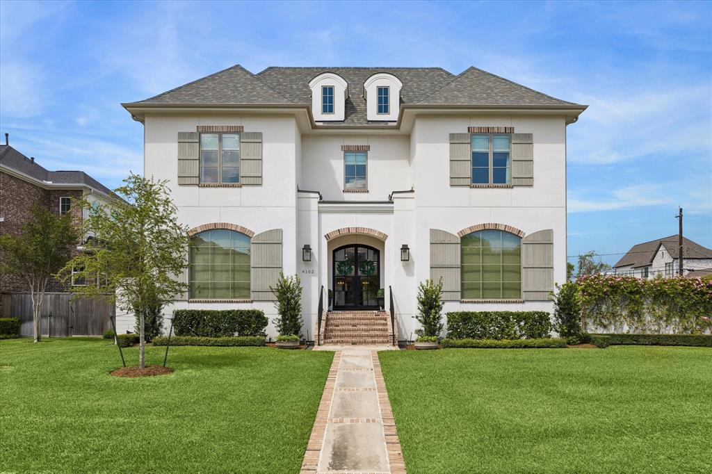 Nestled on an oversized corner lot in the heart of the coveted Braes Heights area, this modern French cottage was masterfully custom built by Frankel Homes in 2019. With a timeless stucco and brick façade boasting a grand rose and ivy wall, the warmth and charm of this home are undeniable as you arrive. Inside, the intentionality of the owner is evident- the custom millwork, wood beams in the family and primary suite, designer and antique mirrors and lighting throughout, three sets of hand-selected antique doors, gourmet kitchen boasting a Wolf sub-zero appliance package, wine refrigerator, and quartzite countertops all showcase craftsmanship at the finest caliber.  The main level offers open concept living between the family room, dining and kitchen, with French doors leading to the veranda, perfect for indoor-outdoor hosting. The unparalleled primary suite featuring stackable washer and dryer connections in the closet, a spacious study, powder room, and mud room complete the first floor. The second level includes three bedrooms with private en-suite bathrooms, laundry room, game room, exercise room and media room. The home features a boastful outdoor space thoughtfully designed to face the side of the home allowing for rare privacy within the city. The show stopping exterior features a professionally designed, French garden inspired yard including a heated pool and spa, brick veranda with outdoor kitchen, fireplace, and oversized ceiling fan to keep you cool even in the summer months. Additionally, the home features a gated entrance and whole home generator, giving you peace of mind 365 days per year. Ideally located near Rice Village, Rice University, The Galleria, Med Center and zoned to Bellaire High School, Pershing Middle School and Mark Twain Elementary, the location blends convenience with premier opportunity.  Designed with hospitality and comfort at the forefront, this home is sure to please those seeking the versatility to host an array of gatherings.