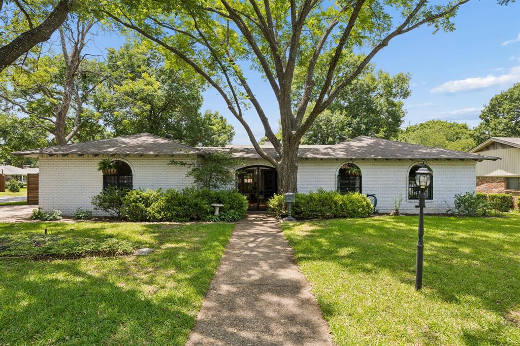 Perfectly positioned on an expansive corner lot, anchored by mature oak and pecan trees, this 4 bedroom, 2.5 bathroom gem offers over 2,300 square feet in the social and sweet Casa Linda Forest neighborhood. Practically doubling the living space to provide endless hosting and enjoyment potential, you'll find a unique atrium entry behind a custom iron gate. Inside, the living space draws you through the foyer with its cathedral ceilings, exposed beams, and wood-burning fireplace bathed in light with expansive views to the backyard. Cathedral ceilings carry through to the bright primary suite with attached bathroom and direct backyard access. Three other bedrooms are well proportioned with plenty of storage. Bonus spaces include a study or playroom off the utility room plus a separate sitting or living area off the atrium -- creating a beautiful flow for entertaining or simply offering another space to enjoy the unique outdoor but indoor experience an atrium provides. The large wrap-around backyard gives plenty of space for a playscape, fort, tables and chairs, with crepe myrtles and trumpet vines growing along the 8 foot fence -- the perfect spot to watch the hummingbirds and butterflies. Casa Linda Forest is a friendly and walkable neighborhood less than 5 minutes from White Rock Lake, Dallas Arboretum, Casa Linda Plaza and many wonderful parks. Other features include: newer fence, loads of storage, recently painted exterior, freshly painted kitchen cabinets, and more.