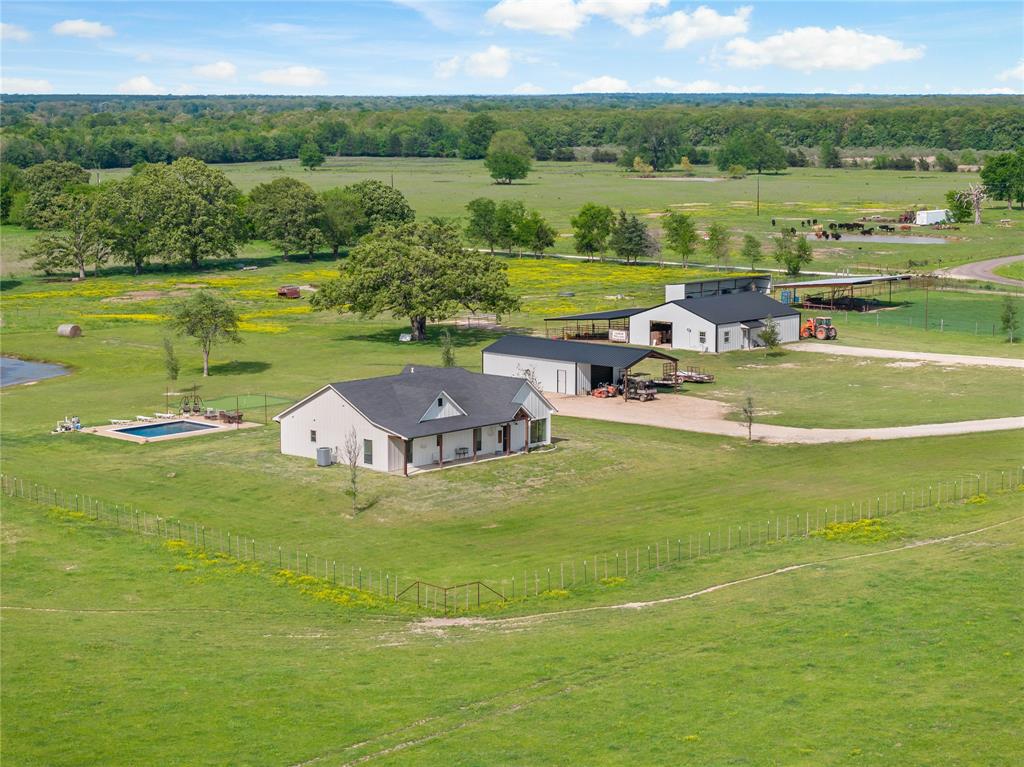 Welcome to this exceptional 45-acre property, offering a perfect blend of luxury and ranching lifestyle. This   crafted 3-bedroom, 2-bath home features a spacious, open floor plan that flows seamlessly from room to room. 
  The hand crafted kitchen is complete with farm sink, granite countertops,and custom cabinets. A gas stove and ample counter space provide additional seating and the perfect setting for culinary enthusiasts. The kitchen island overlooks the swimming pool, and putting green and has spectacular views of the property.   
The master suite features a distinct bathroom with a separate tub and shower. This living space includes a large walk-in closet, with ample room perfect for organizing your wardrobe.
For your equine friends the property includes a 5 stall horse barn , with an additional, 1 bedroom, 1 bath, 1000 sq ft living space for your visitors.  The adjacent 250 x 120 roping  arena is equipped with a return alley, covered roping boxes as well as covered livestock working pens. These covered areas are also equipped with lighting .  Additionally there is  a 30x60 insulated shop building providing a great space  for projects, equipment, and more.
There are approximately 40 Acres of cross fenced improved pastures with access to water sources.