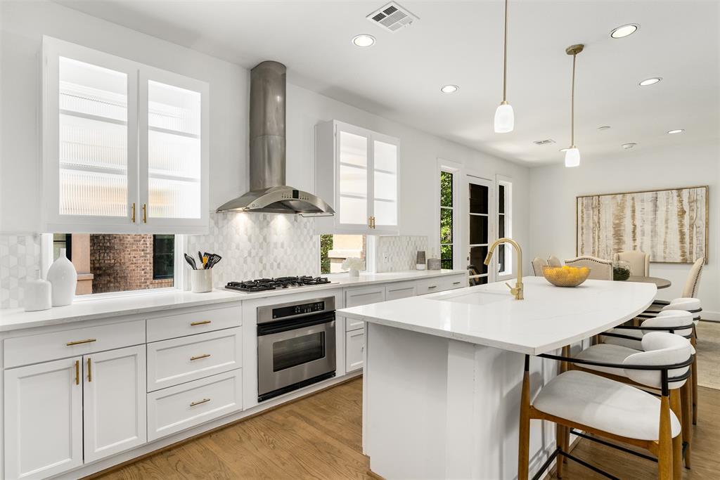 An Unrivaled Opportunity in Oak Lawn Positioned significantly below tax assessment and recent area comparables, this exceptional brownstone-inspired townhouse offers an elite urban lifestyle with absolutely no HOA fees. Strategically priced for immediate market response, this residence commands attention. Sealed offers will be entertained through June 24 at 7pm following two exclusive open house viewings this week. Boasting a rare 95 Walk Score, this Walker’s Paradise sits blocks from Highland Park, the Katy Trail, Uptown, and Turtle Creek. The thoughtful multi-level design features dual fireplaces, refined split-bedroom privacy, and multiple private outdoor spaces—including a fenced front courtyard, a gated office patio, and downtown views from the east-facing balconies.The second-level great room integrates living, dining, and a chef's kitchen equipped with a gas cooktop, expansive island, and premium wet bar with a wine chiller. The entire third floor belongs to the palatial primary retreat, complete with a double-sided fireplace, freestanding soaking tub, skylight, and an oversized boutique wardrobe. Modern upgrades include a new tankless water heater, updated appliances, and flexible aesthetic finishes (gold hardware may be transitioned to silver upon request). Take advantage of standard single-family mortgage rates on this fee-simple property. View the cinematic RealKit video tour in the media link.