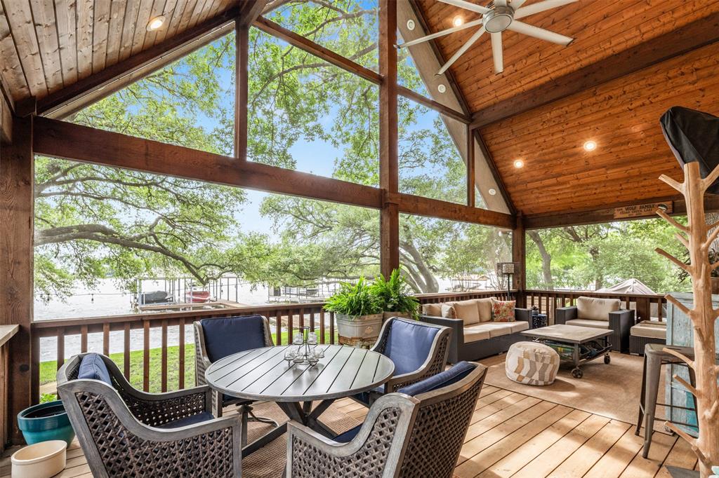 Discover the perfect lakefront getaway in this beautifully renovated home on the shores of Cedar Creek Lake. Nestled among mature trees with panoramic water views, this stunning retreat offers the best of indoor-outdoor living—and the chance to make a lifetime of unforgettable memories.
Step inside to a fully updated interior where every detail has been thoughtfully designed. The open-concept main living area boasts vaulted ceilings and a wall of folding doors that open seamlessly to a spacious screened-in patio, bringing the outside in and offering breathtaking sunset views over the water. The heart of the home is a modern kitchen featuring a large center island—ideal for gathering with family and friends. A stylish powder bath and laundry room with convenient outdoor access make lake days effortless.The serene primary suite offers a spa-inspired bath with a soaking tub and a luxurious walk-around shower. Upstairs, two inviting guest bedrooms provide space for family and visitors. Separate from the main house, a private guest suite offers additional comfort with a full bedroom, walk-in shower, and peaceful privacy—perfect for hosting weekend guests or multi-generational stays. Outdoors, enjoy a covered dock ready for your boat and jet skis, shaded by towering trees and perfect for launching a day of lake adventure. The detached garage and generous parking space ensure there's room for everyone. Whether you're sipping coffee on the patio, watching the kids jump off the dock, or winding down with a glass of wine as the sun sets over the water, this lakefront haven is a place where memories are made.
**This is more than a home—it's your lakeside sanctuary, just an hour from the city, and a world away from it all.**