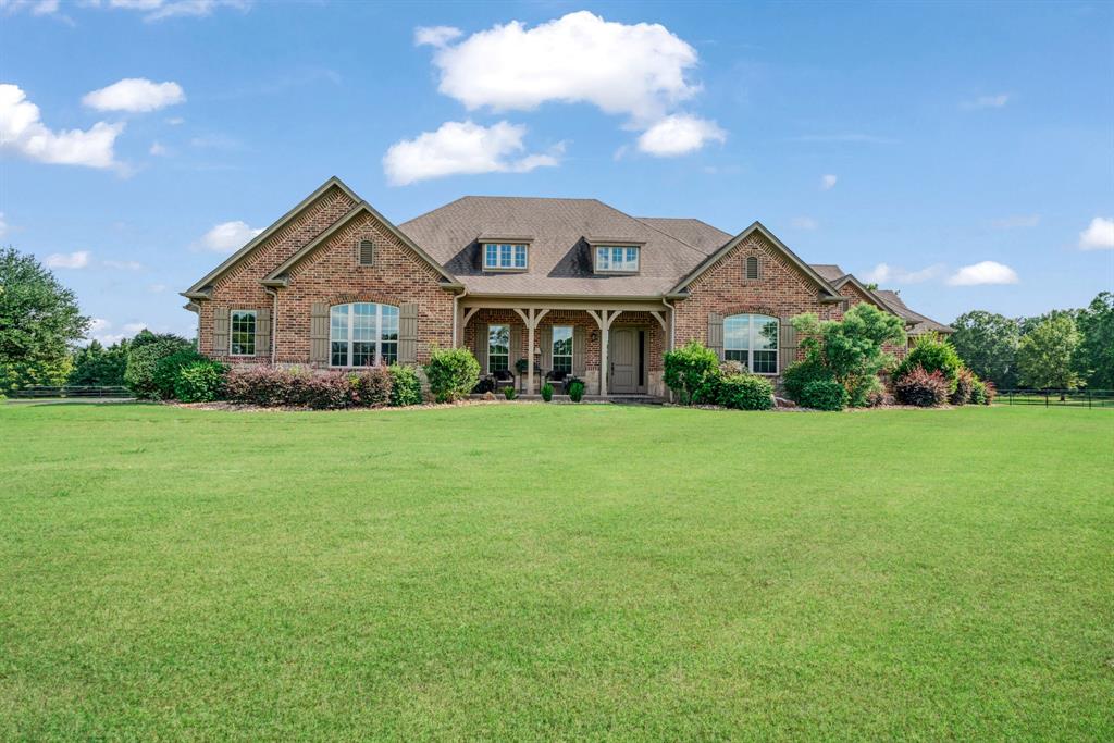 Luxury Country Estate on 26.78± Acres with Water Rights, Manager’s Quarters & Equestrian Amenities.
Nestled along the highly desirable FM 195 corridor of Lamar County Texas— directly across from the Paris Golf & Country Club — this estate offers an ideal blend of luxury, privacy, convenience, and agricultural value. With 26.78± acres of lush, gently rolling terrain, pipe fencing, a paved driveway, and two stocked ponds, the property provides a tranquil country retreat while still being just minutes from downtown Paris, local amenities, and recreational options.

The custom brick residence brings together comfort and refinement. High 10-foot ceilings, hardwood floors, recessed lighting, and a cozy gas fireplace create a warm, welcoming ambiance. The chef’s kitchen is outfitted with granite countertops, custom cabinetry, a large island, gas cooktop, walk-in pantry — perfect for both everyday living and entertaining. Formal dining, a dedicated office, and en-suite bedrooms offer both practicality and privacy for family or guests. The oversized two-car garage adds convenience and easy access.

Beyond the main home, the property is designed for versatility and lifestyle. A full Manager’s Quarters delivers a self-contained one-bedroom apartment — modern kitchen, stainless-steel island, attached laundry, covered porch — ideal for live-in help, a guest suite, or multi-generational living. For added flexibility, an attached man cave with private bath provides an excellent workshop, recreation space, or guest lounge.

For the equestrian or livestock enthusiast, the barn with multiple stalls and covered turnouts is ready to go — fenced pastures provide ample room for horses or cattle. Meanwhile, the two stocked ponds offer year-round enjoyment — fishing, wildlife, water views — enhancing both the leisure and aesthetic value of the estate. 

This property represents a rare opportunity: a ready-to-live, turnkey luxury estate, equestrian use, or long-term investment.