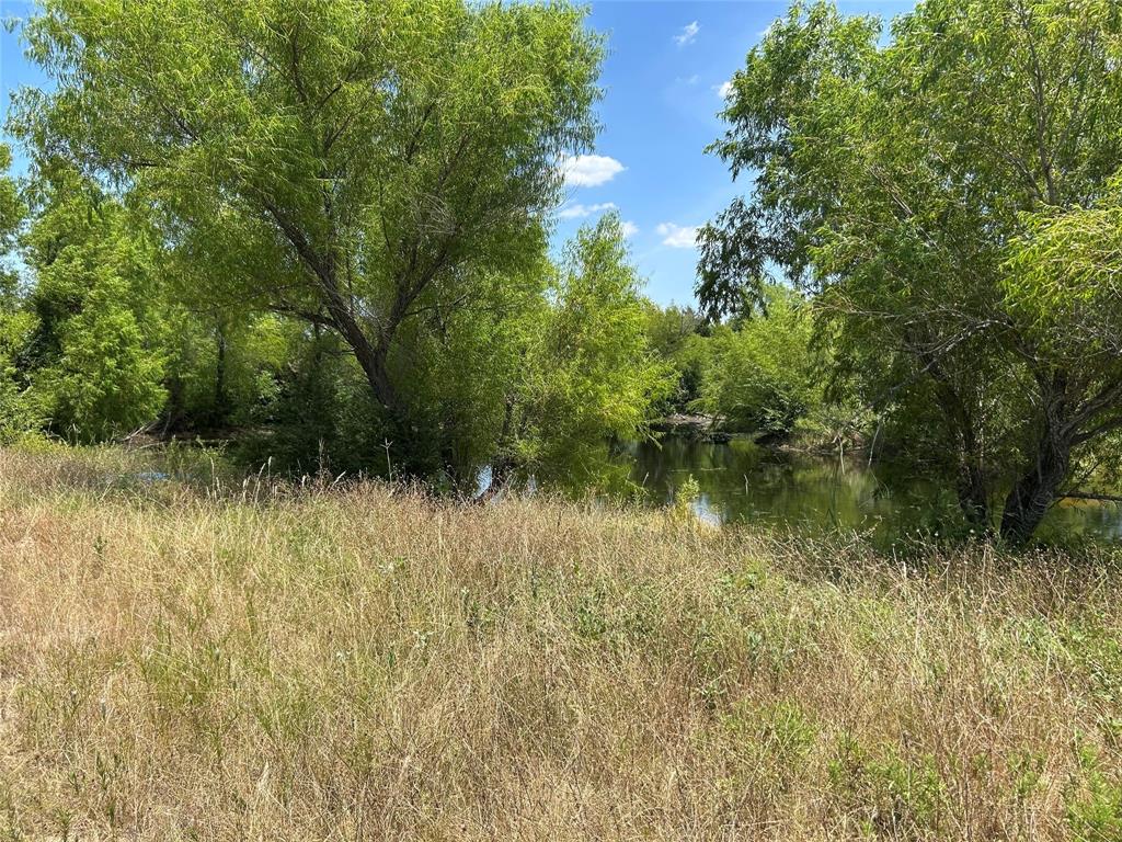 Dreaming of wide-open spaces, star-filled skies, and the peace and quiet that only country living can offer? This rare 32.9 acre spread in fast-growing Collin County is the perfect place to make that dream a reality. Whether you’re looking to establish your forever homestead, run livestock, or hold as an investment for future development, this property checks all the boxes.  This is true Texas ranch land, partially cleared and partially wooded, offering a mix of pasture, native grasses, and lots of privacy. The land is fully fenced with barbed wire and metal making it ideal for cattle, horses, or other livestock. It’s ag exempt for low property taxes. There's a beautiful 1-acre stocked pond with bass and crappie, featuring a small island in the middle—ideal for fishing, relaxing, or picnics.  There's a seasonal creek at the back of the property that attracts deer, hogs, and other wildlife.  The property is flat and has gently rolling topography with cleared pastureland, grassy meadows, and tree lines providing shade and privacy.  Improvements include a 25x60 horse barn and a 20x20 storage barn for equipment or feed.  There are two electric meters, and electricity is provided through the co-op.  There is an easement providing close access to a water line.  Asphalt road frontage along FM Road, City Street, and County Road—ideal for access from multiple points.  This property is currently used for cattle and horses, but the possibilities are endless. Build your dream home, create a weekend getaway, or subdivide and develop (buyer to verify). There is plenty of room to spread out, enjoy nature, and create the rural lifestyle you’ve always wanted—all while still being close to Farmersville and a manageable drive to the DFW Metroplex. Property is occupied. It is a go-show—no appointment needed—but enter at your own risk. Snakes have been spotted. Buyer to verify all information including room dimensions, school boundaries, zoning, and MLS details.