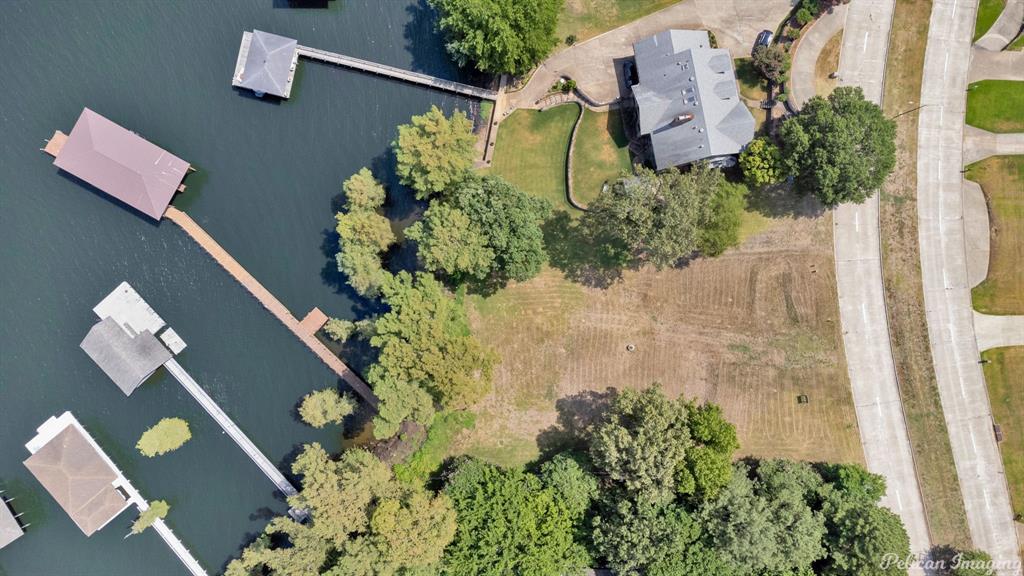 Did the end of Summer have you wishing you owned waterfront property? Well then check out this last Lake Front Lot of it's kind! Fantastic location on South Lakeshore Drive Located just minutes from I-220 and I-20. Loads of potential and a home that would provide endless sunset views. Enjoy lake days and have direct access as a homeowner with this fabulous boat house and pier! Boat house has 3 slips for boat storage and a side deck with another landing with a ladder at the furthest point of the pier.