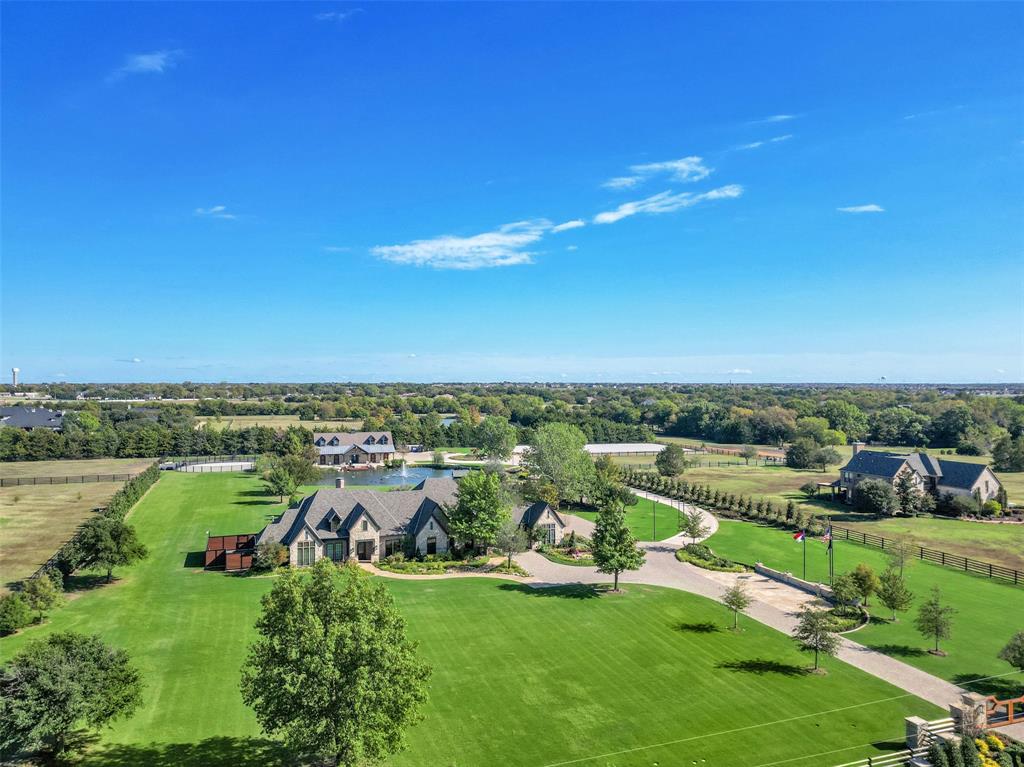 Minutes from downtown Dallas! Rick Shipley Custom Home. This stunning estate sits on 13.432 acres. Beautifully renovated w every detail imaginable. Stunning views of the grounds from entry & great room. Unlike anything on the market! Chef’s kitchen with Quartzite counters, Wolf & Subzero appliances. Well-appointed primary suite w views, fireplace, true spa bath & custom closet. Lg flex room, laundry & guest suites complete the main level. Second level offers a lg game room w views, wet bar, full bath, & separate media room that’s perfect for entertaining or guest area.  Stroll the spectacular grounds & enjoy the covered patio w outdoor grill, pool & spa w sundeck, large private pond, dressage arena, & 6 paddocks.  The action-packed barn is for the equestrian at heart! 5 stalls, wash station, office flex space, tack room & half bath.  Additional 1,100 sf guest quarters w kitchen, living, bedroom & full bath. Grounds irrigated from a well. Short distance to Lake Ray Hubbard.