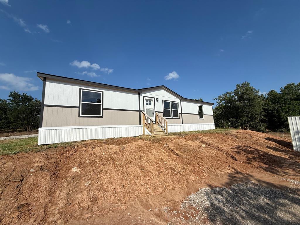 All offers will be considered. This nearly new home sits on over 2 beautifully treed acres. The newly installed gravel driveway leads you to the privately placed home. So much potential on this lot. You could build a shop, grow a garden or run your business.No known restrictions. Inside the home has a very nice kitchen with stainless steel appliances and ample cabinet space along with a butlers pantry and refrigerator. Split bedrooms and ensuite primary bathroom. 2 miles down the road is North Side Marina & Resort where you can launch your boat and explore the resort amenities. Come enjoy country living. Please contact listing agent with questions regarding the owner finance option.