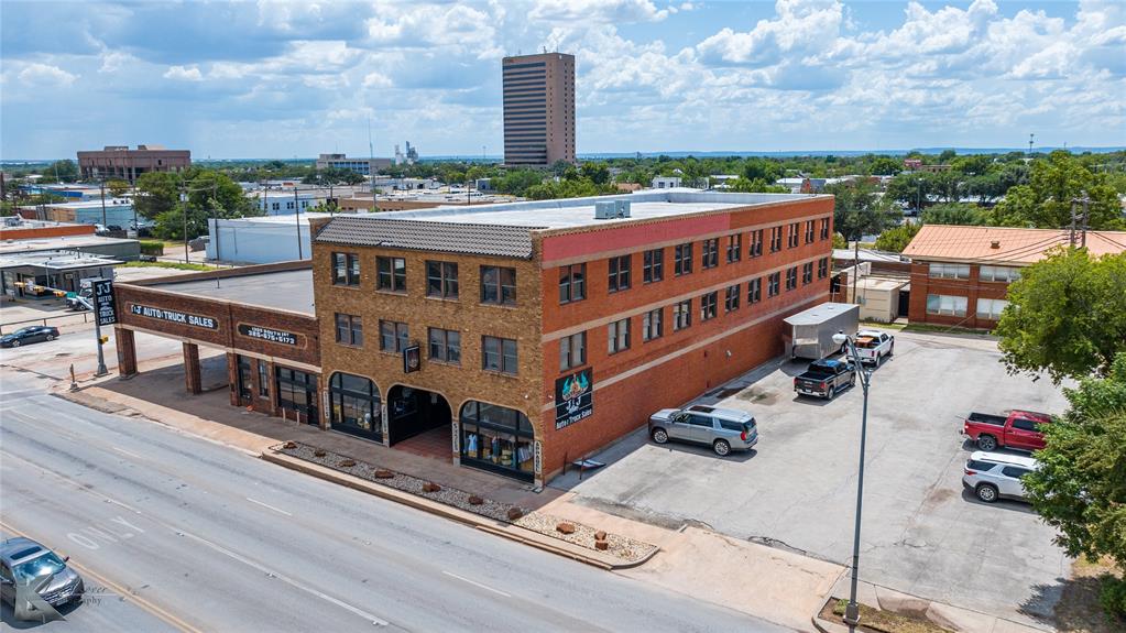 Calling all investors! This Historic three-story brick building with 19,260 square feet is prime for redevelopment & mixed use. The first floor is currently used for retail & has been home to YaYa Gurlz for the past decade. The second & third floors are a blank canvas for urban condos, office space or any number of other creative uses. The building comes with a parking lot with approximately 30 parking spaces. There is warehouse space with an overhead roll up door on the alley side of the property. Located on South 1st near the intersection of Butternut, there is a high traffic count & high visibility. This historic gem is also conveniently located near Downtown Abilene & the SODA District. 

This property could also be purchased with 1305 South 1st located right next door at the corner of South 1st & Butternut. See listing #21032117 for more details.