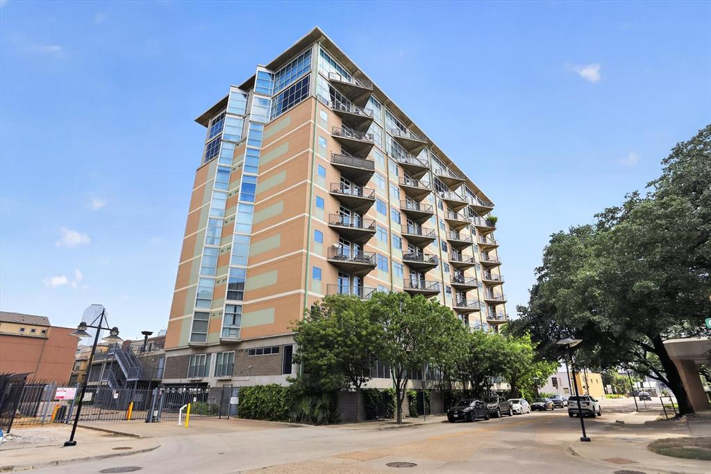 Experience upscale urban loft living in this stylish 2-bedroom, 2-bath condo located in the highly sought-after Cedars neighborhood, just minutes from Downtown Dallas. This modern open-concept floorplan features soaring 11-foot ceilings, polished concrete floors, and dramatic floor-to-ceiling windows that fill the space with natural light. The gourmet kitchen is equipped with stainless steel appliances, marble countertops, and ample cabinet space, making it perfect for entertaining. Split-bedroom design offers added privacy, with the spacious primary suite featuring an ensuite bath and walk-in closet. Enjoy breathtaking Dallas skyline views from the community amenity deck. Resort-style amenities include a sparkling pool, hot tub, BBQ grilling area, fire pit, and gated parking garage with an assigned tandem parking space. Conveniently located near shopping, dining, entertainment, and vibrant nightlife.
