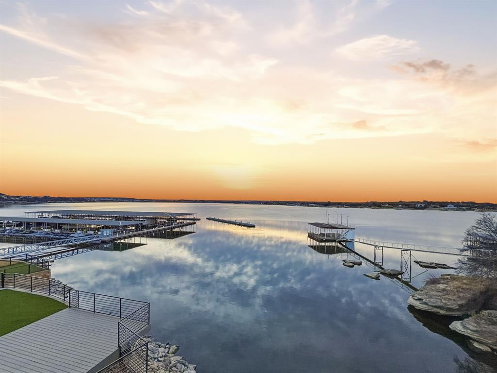 Arguably one of the best views on Possum Kingdom Lake, this exceptional property offers the perfect blend of comfort, convenience, and lock-and-leave living. Designed for both relaxation and entertaining, the home features two separate living areas with two spacious patios, allowing you to fully take in the breathtaking lake scenery from multiple vantage points. This turn-key, low maintenance property is ideal as a full-time residence or weekend escape! We are located in a short-term and rental-friendly community, offering excellent investment potential. Residents enjoy access to a resort-style pool, pavilion and putting green. You are only steps away from the Juniper Ridge Marina enhancing the lake lifestyle with with ease and luxury!