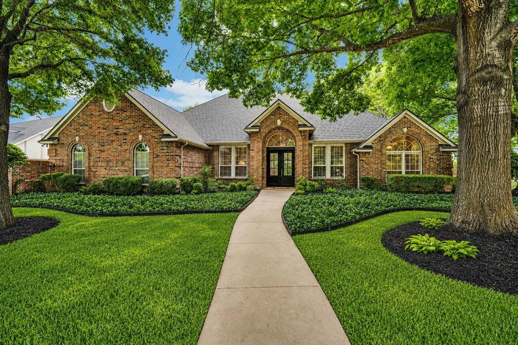 Tucked beneath a canopy of mature trees in the highly sought-after Ashburne Glen, this beautifully maintained one-story home offers the perfect blend of comfort, charm, and thoughtful updates. Situated on a spacious .439-acre lot, 616 Forest Edge Lane features 3 bedrooms, 2.5 baths, a dedicated office, and a 3-car garage across 2,588 square feet. Step inside to find a warm, inviting interior with rich nailed-down wood floors flowing through the main living areas, dining room, office, and hallways. The home has been freshly repainted (2023) and enhanced with updated fixtures and stunning quartz countertops throughout—even extending to the fireplace hearth—creating a cohesive and elevated feel. At the heart of the home, the kitchen is both beautiful and functional, showcasing upgraded appliances, quartz countertops, a stylish backsplash, porcelain farmhouse sink, center island, and a generously sized double-door pantry. The primary suite offers a private retreat with a recently updated, handicap-accessible ensuite featuring a walk-in shower, new fixtures, quartz countertops, and tile flooring—designed for both comfort and ease of use. Secondary bedrooms are comfortably carpeted, while bathrooms feature durable tile finishes. Plantation shutters line the front of the home, adding timeless style and curb appeal. Major updates provide peace of mind, including a new roof (2023), gas water heater (2025), and updated thermostat. Outdoors, the expanded 14x22 patio creates an ideal space for relaxing or entertaining, surrounded by lush landscaping and the natural beauty that defines Ashburne Glen.